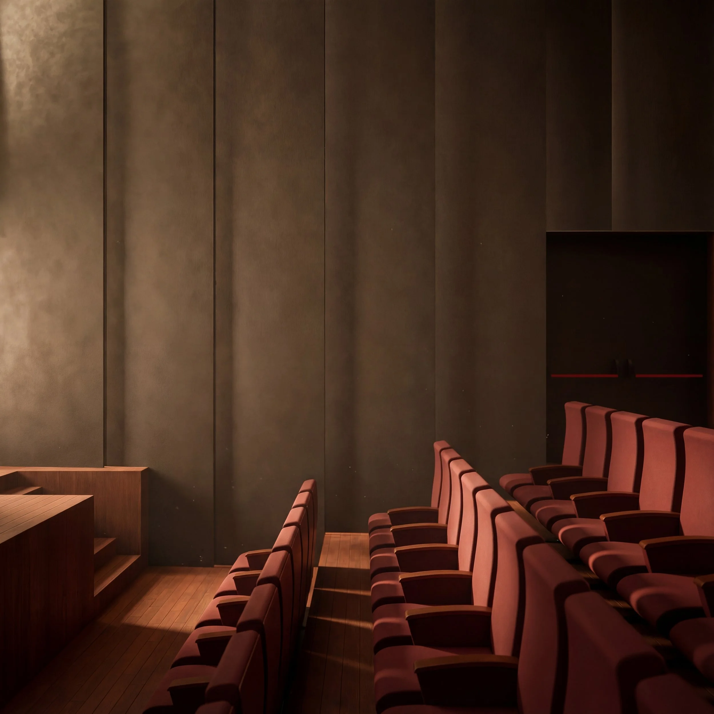 Empty theater with rows of pinkish theater seats in front of a dark wall.