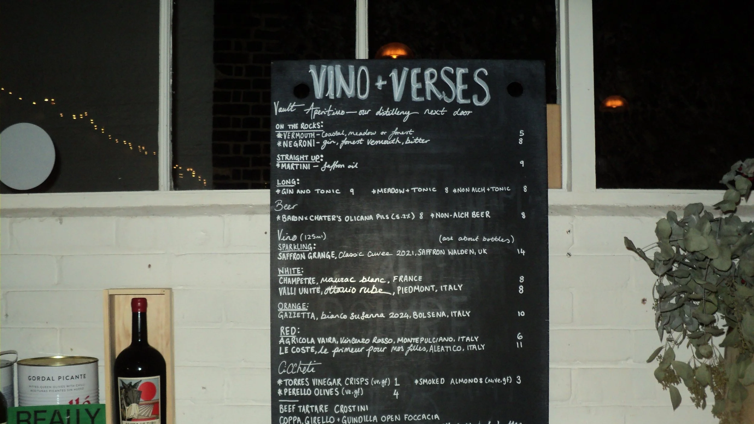 Menu board for a wine and verse tasting event at a winery, listing various wines, beers, and small plates.