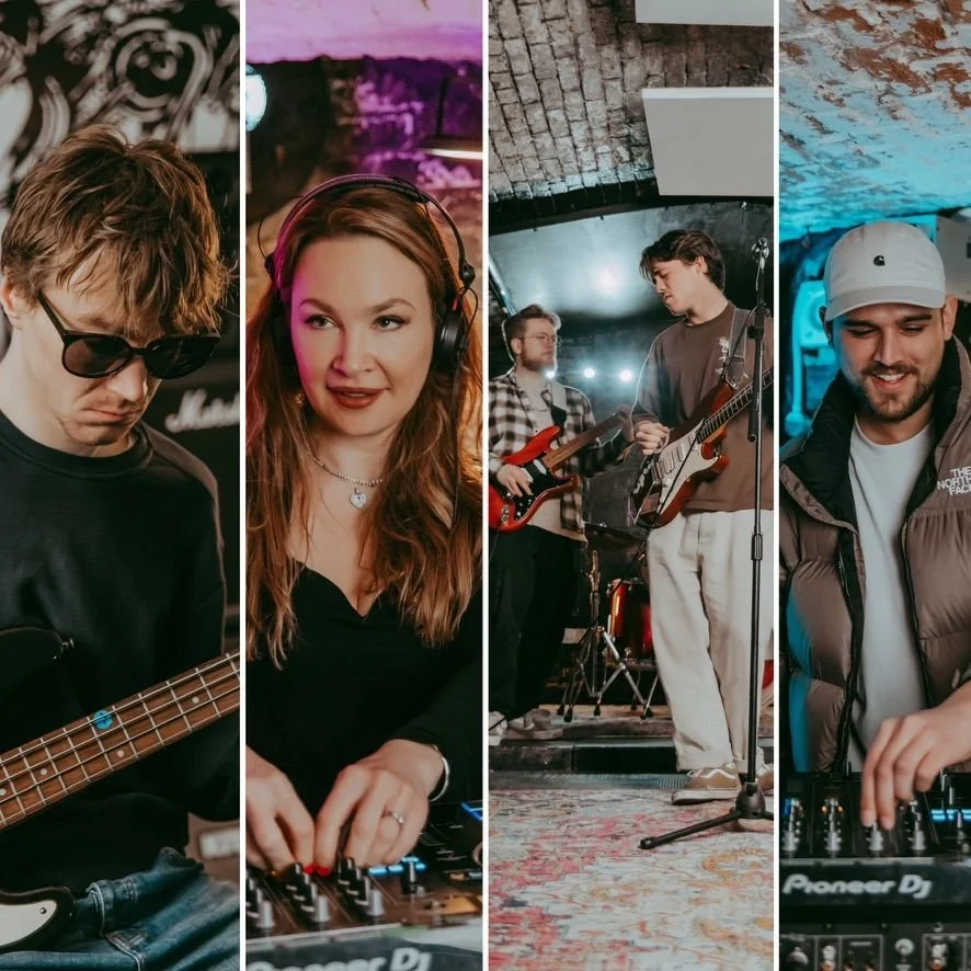 A group of musicians performing in a music venue, including a bassist, a female DJ, two guitarists, and a DJ using a mixer.