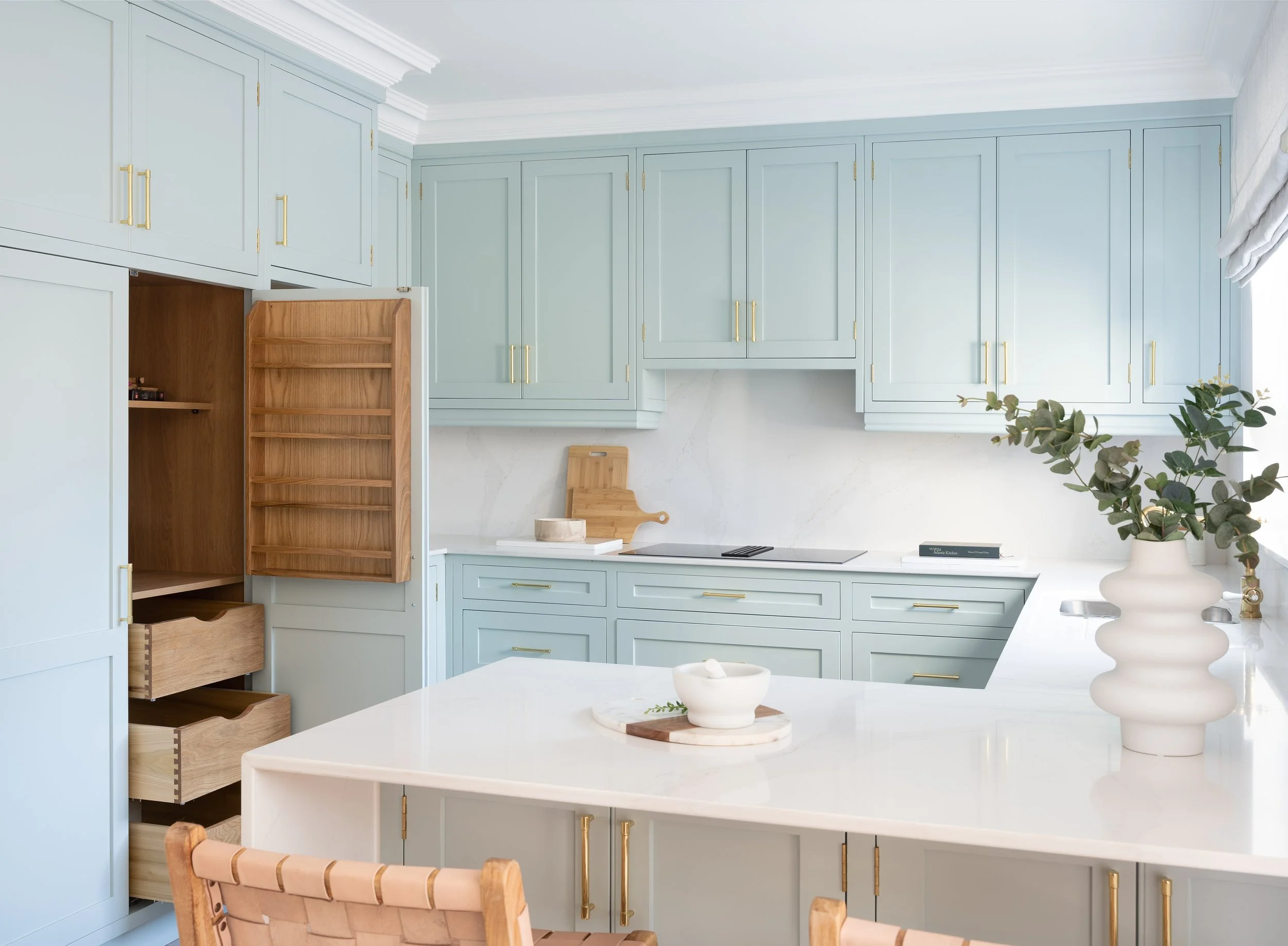 Pale blue show home kitchen at Killarney Townhouse by Aoife Maria Interiors, designed with considered cabinetry, finishes and lighting.