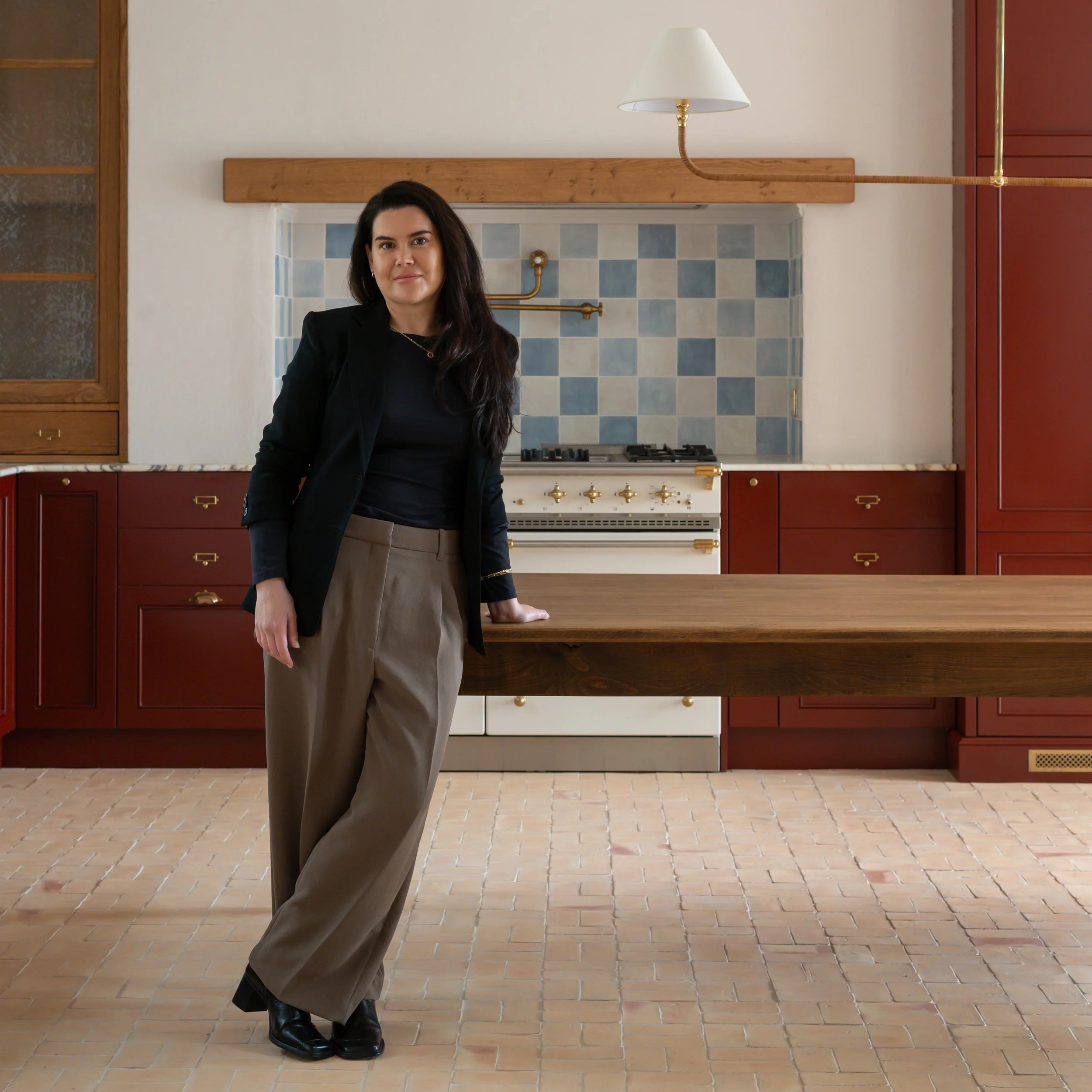 Aoife Tobin, Founder and Creative Director of Aoife Maria Interiors, photographed in a completed residential kitchen.