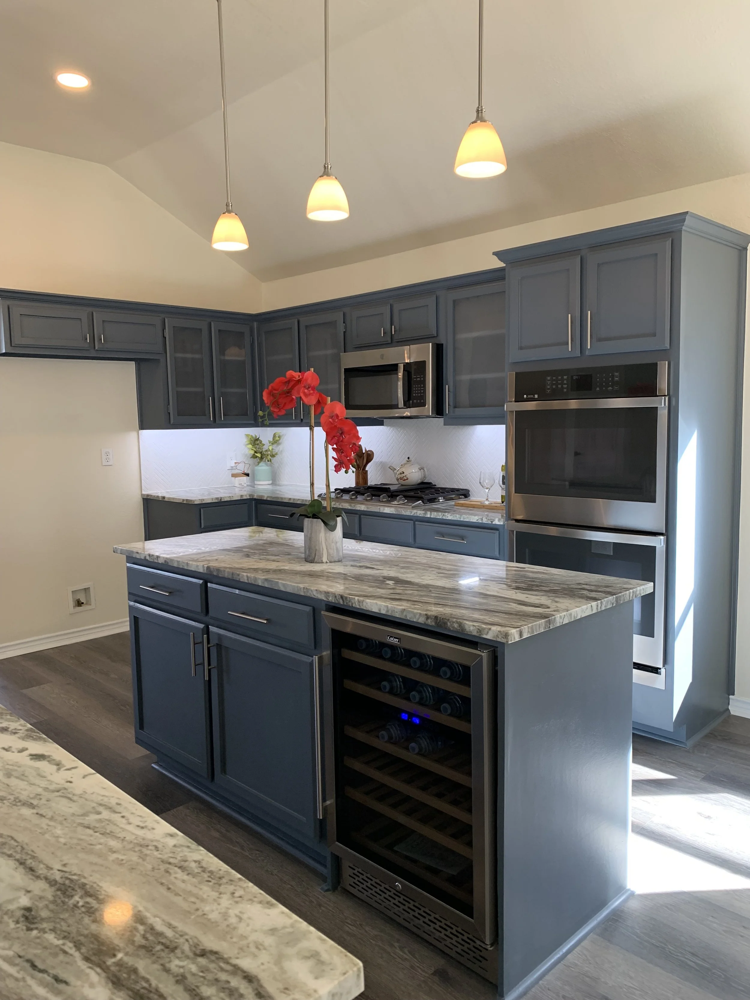 Kitchen: Modernization featuring new countertops, backsplash, flooring, integrated lighting, high-end appliances, an under-counter wine cellar, custom cabinetry, and a refined color palette transform the once-dark space into a bright, culinary hub