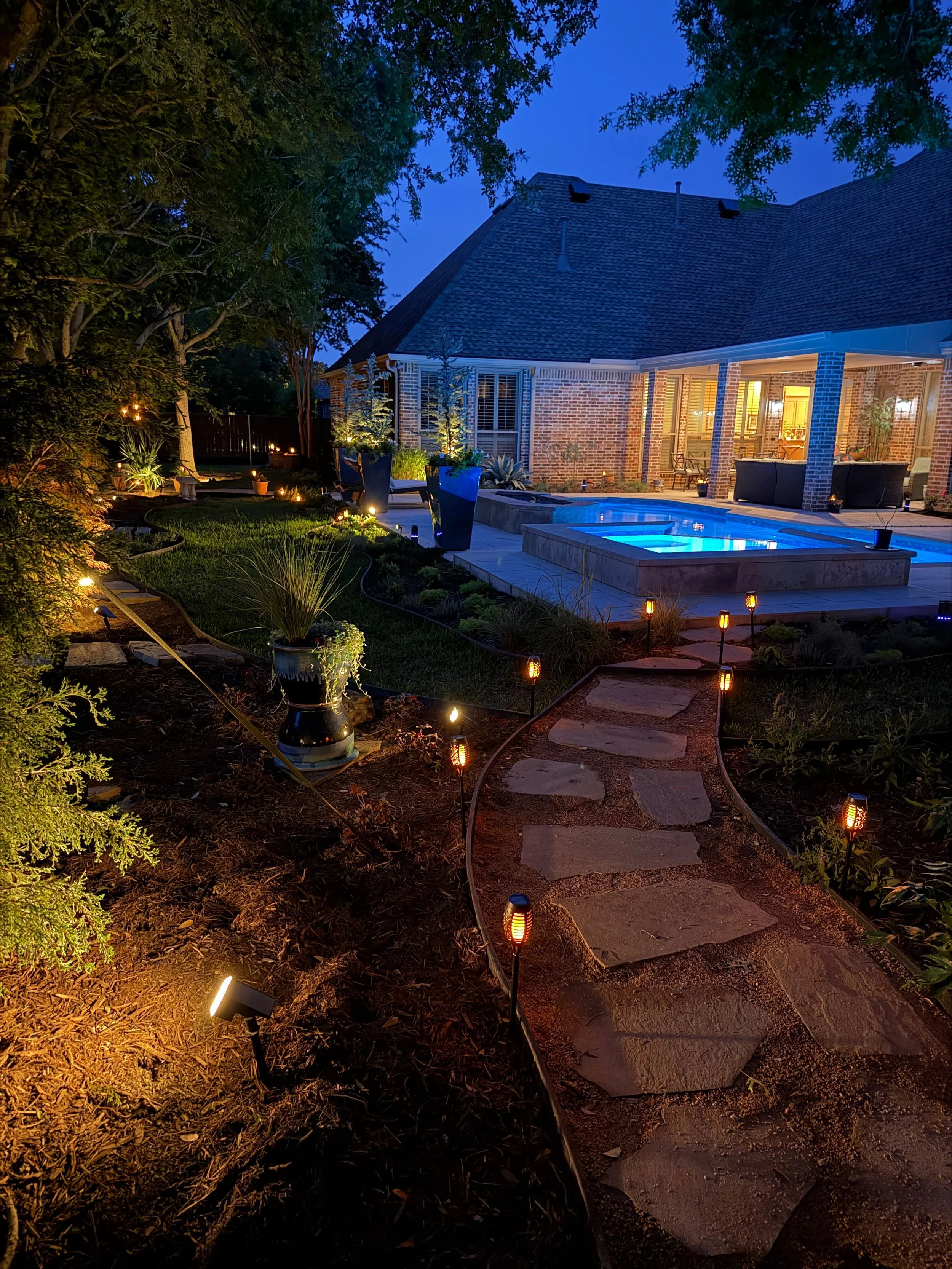 Landscape: Elegant LED lighting provided by Client enhances the landscape design in the evening.