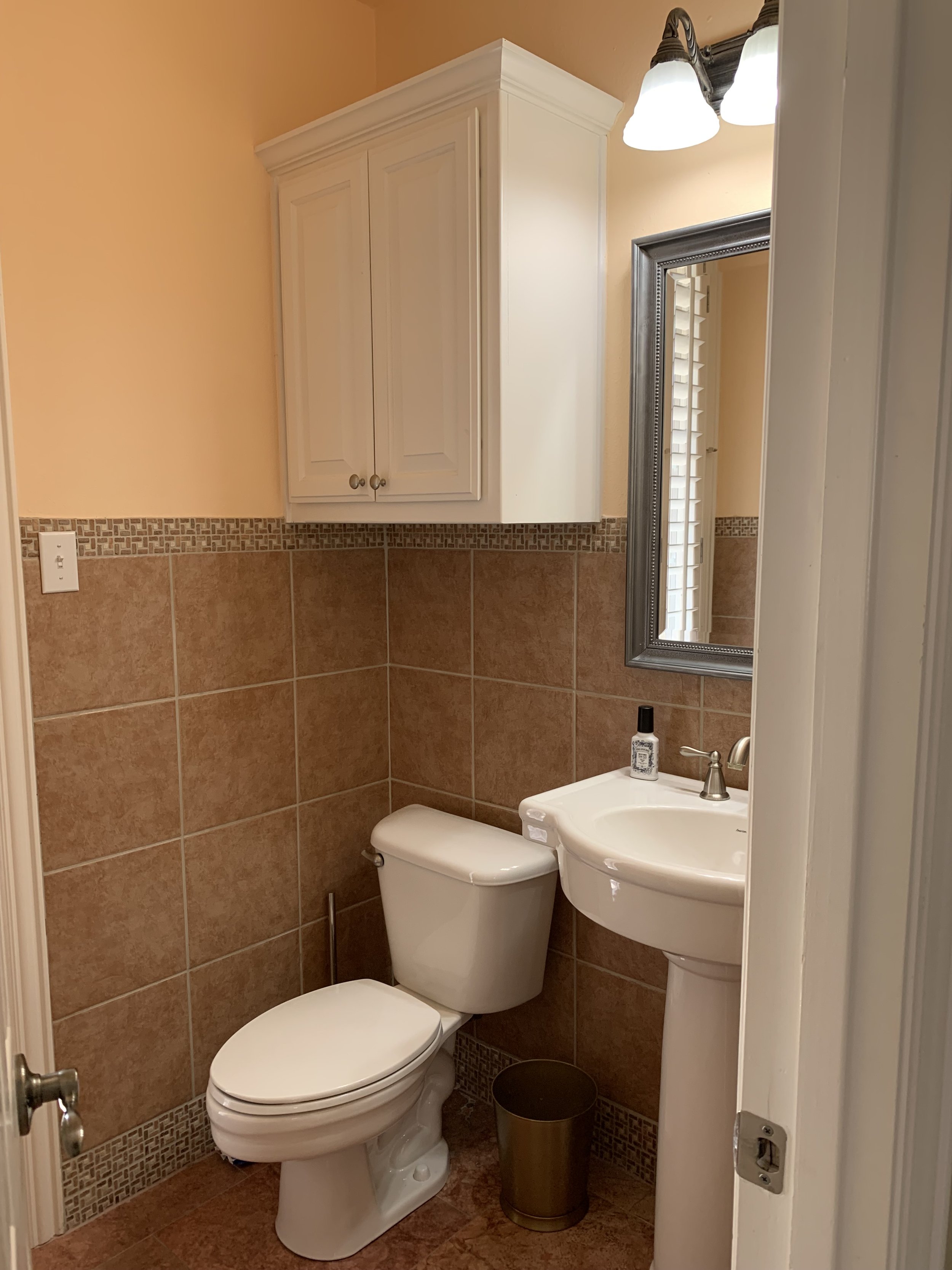 Half Bathroom: Original fixtures and dated finishes (Before)