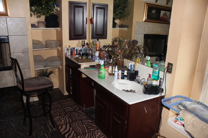 Primary Bathroom: Original layout with dark, heavy finishes created a cramped atmosphere (Before)