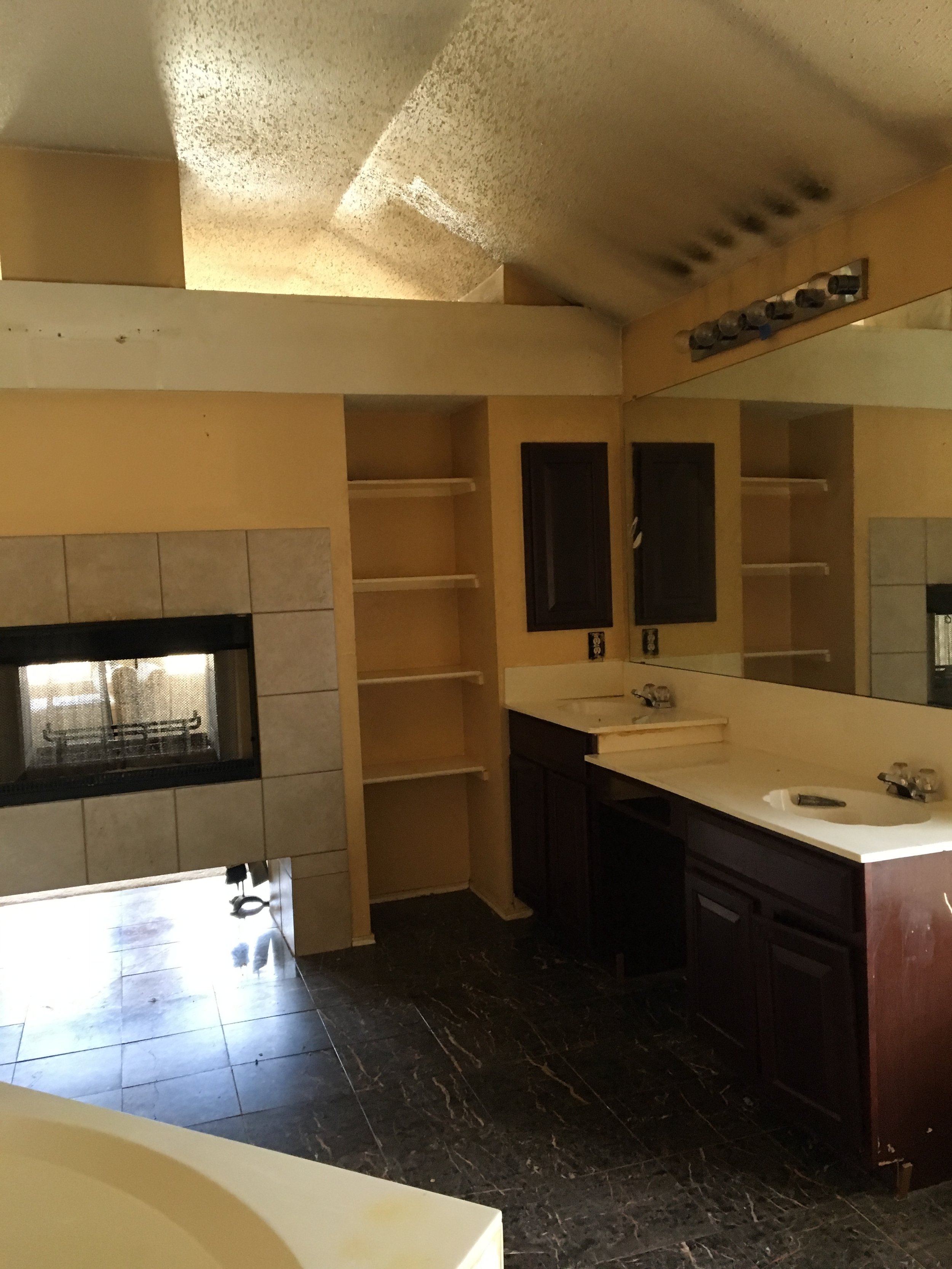 Primary Bathroom: Dated dark cabinetry and a clashing color palette created an uninviting space (Before) 