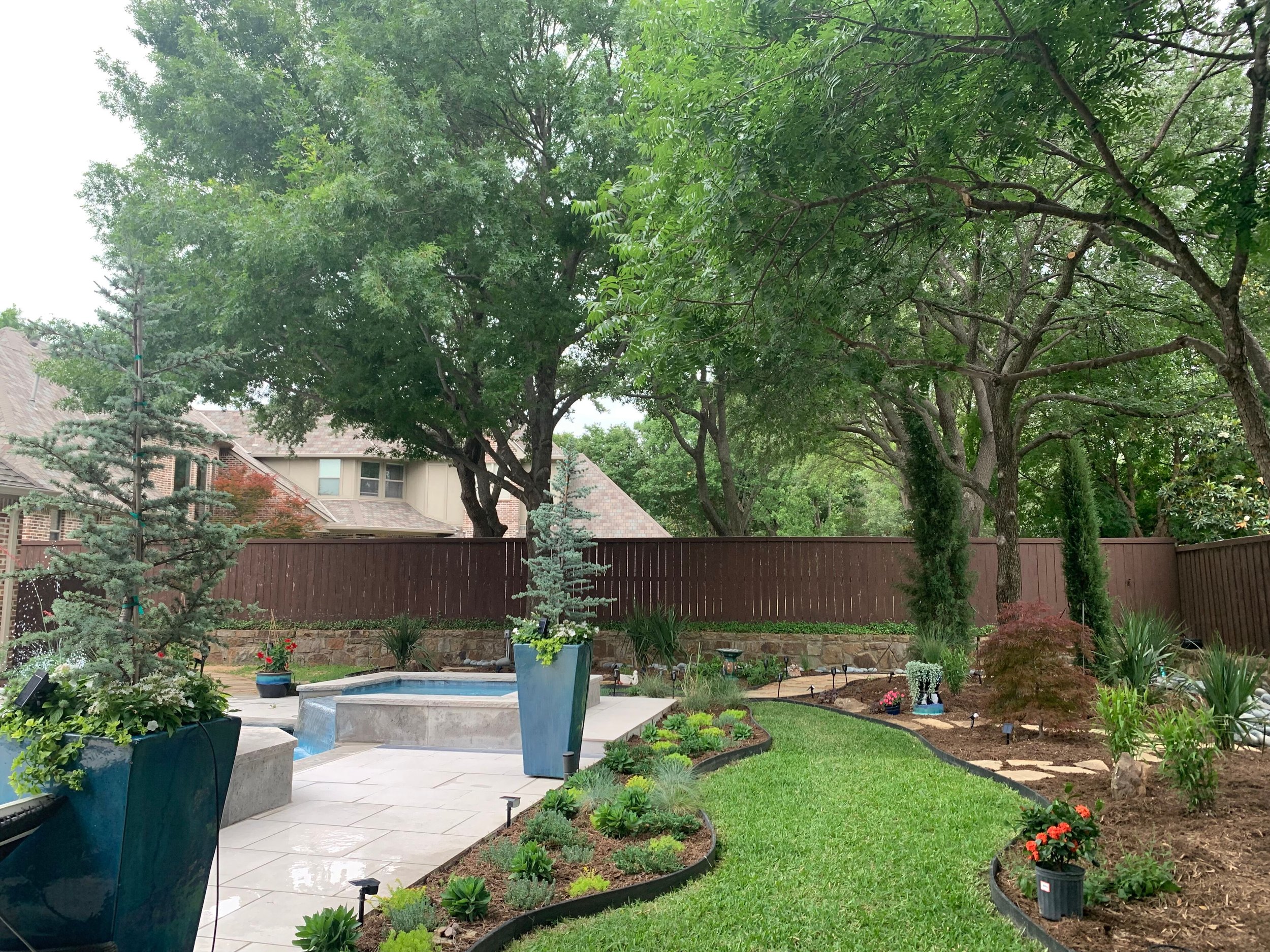 Landscape: New flagstone pavers within the custom planting beds with mulch installation