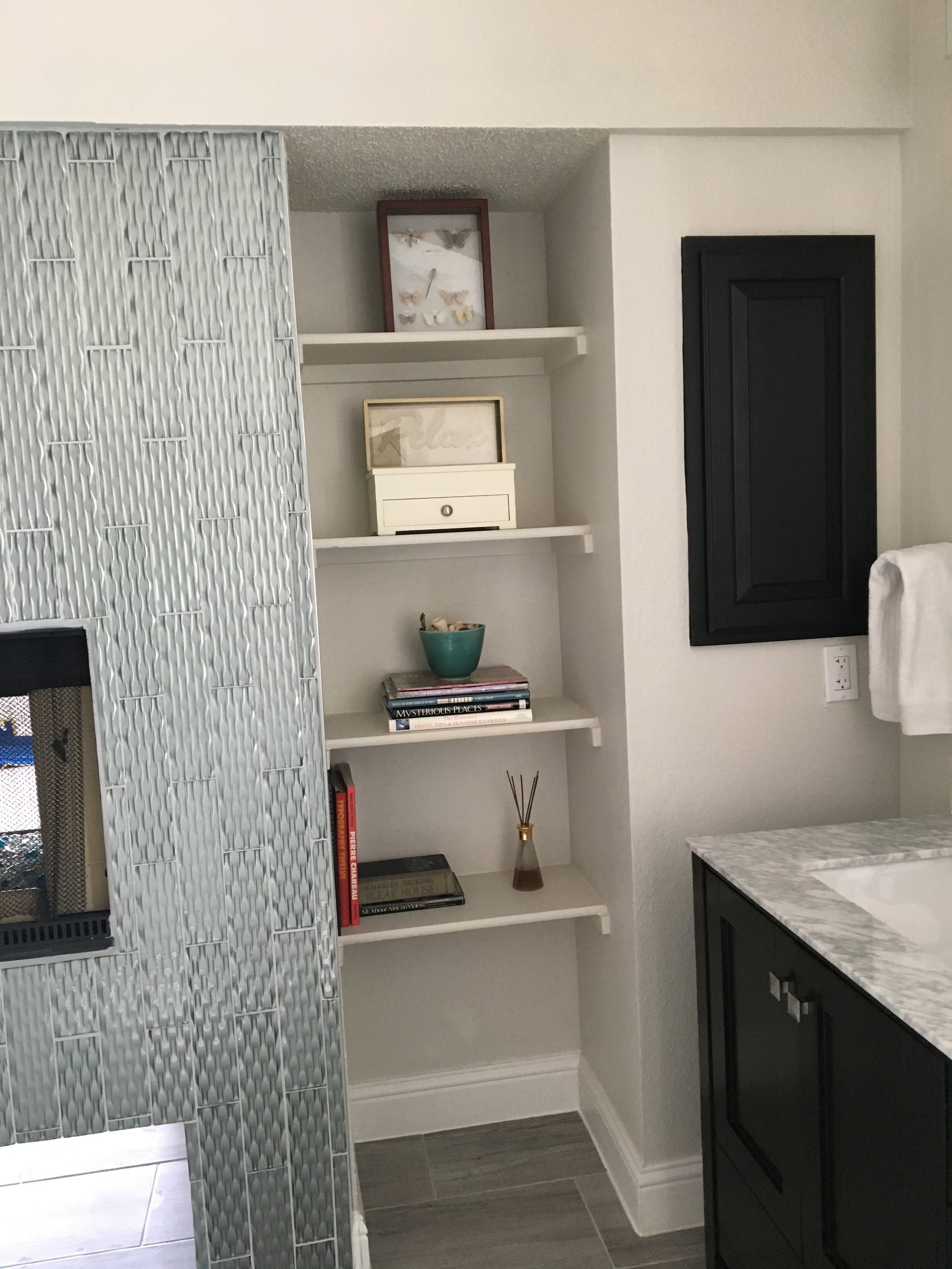 Primary Bathroom: Close-up of custom wall tiling for fireplace and integrated niche