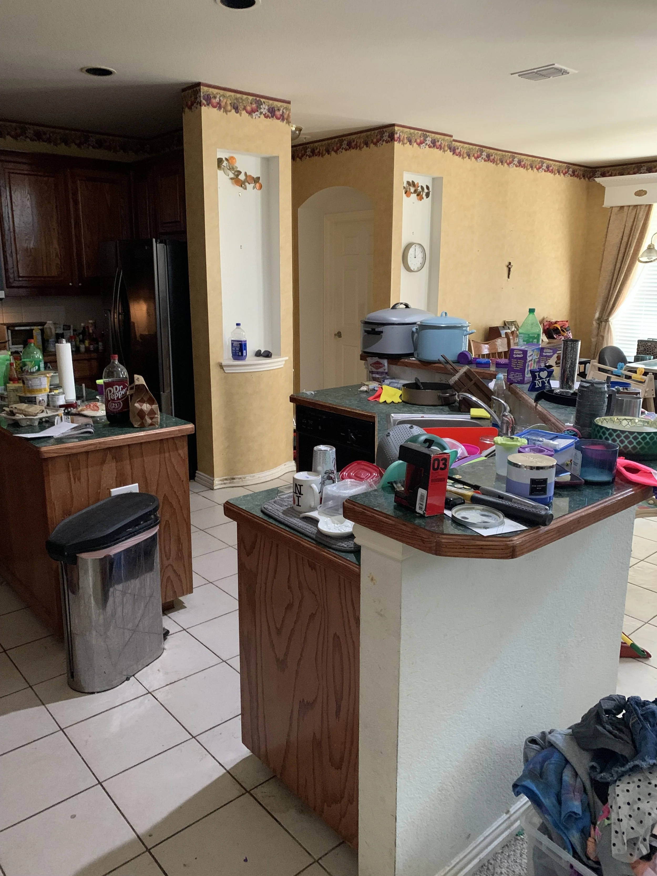 Kitchen: Original cabinetry, lighting, countertops, wallpaper, and appliances weighed down the room (Before)