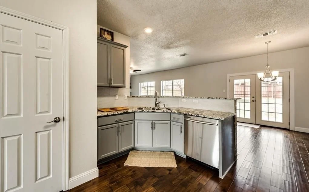 Kitchen: Preservation of the original footprint enhanced by modernized finishes for a clean, cohesive update