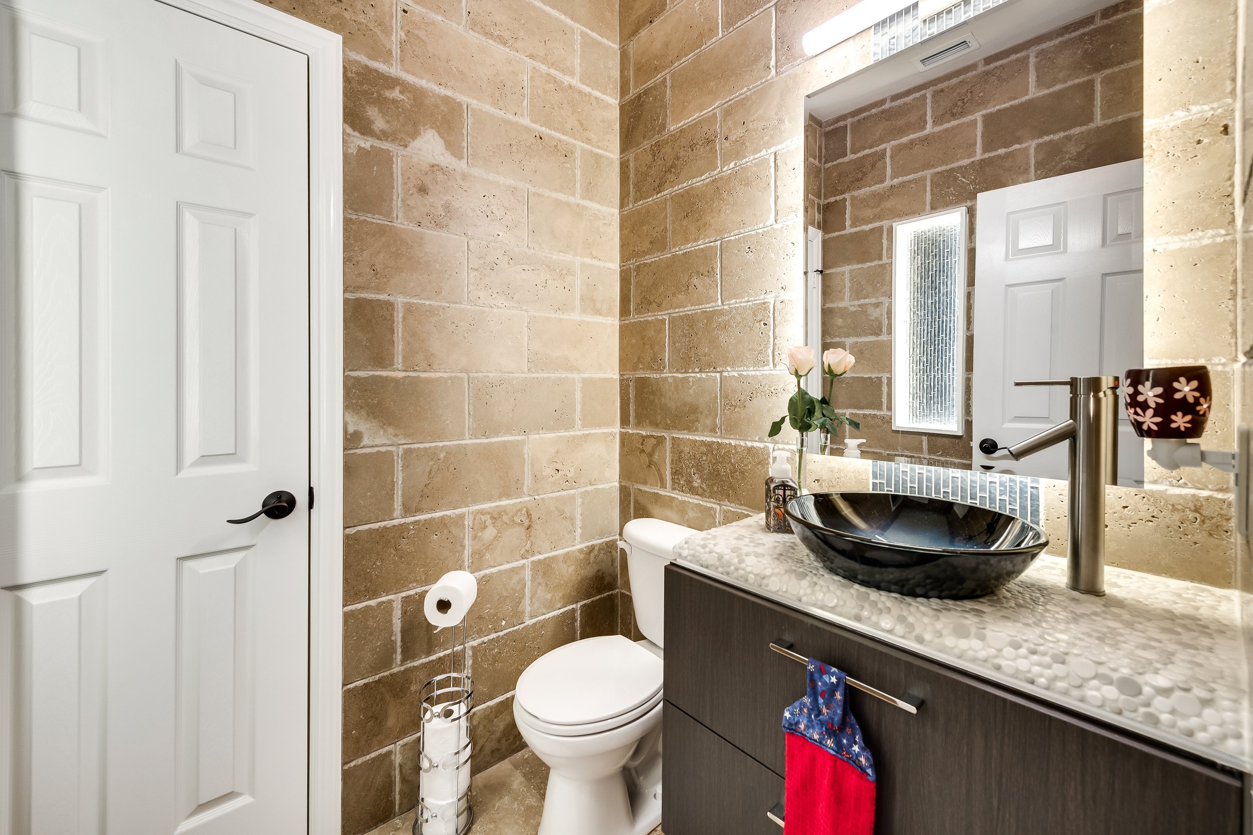 Half Bathroom: New vanity, floating mirror, lighting, integrated wall niche with accent LED lighting, cohesive color palette, and updated wall and floor tiling