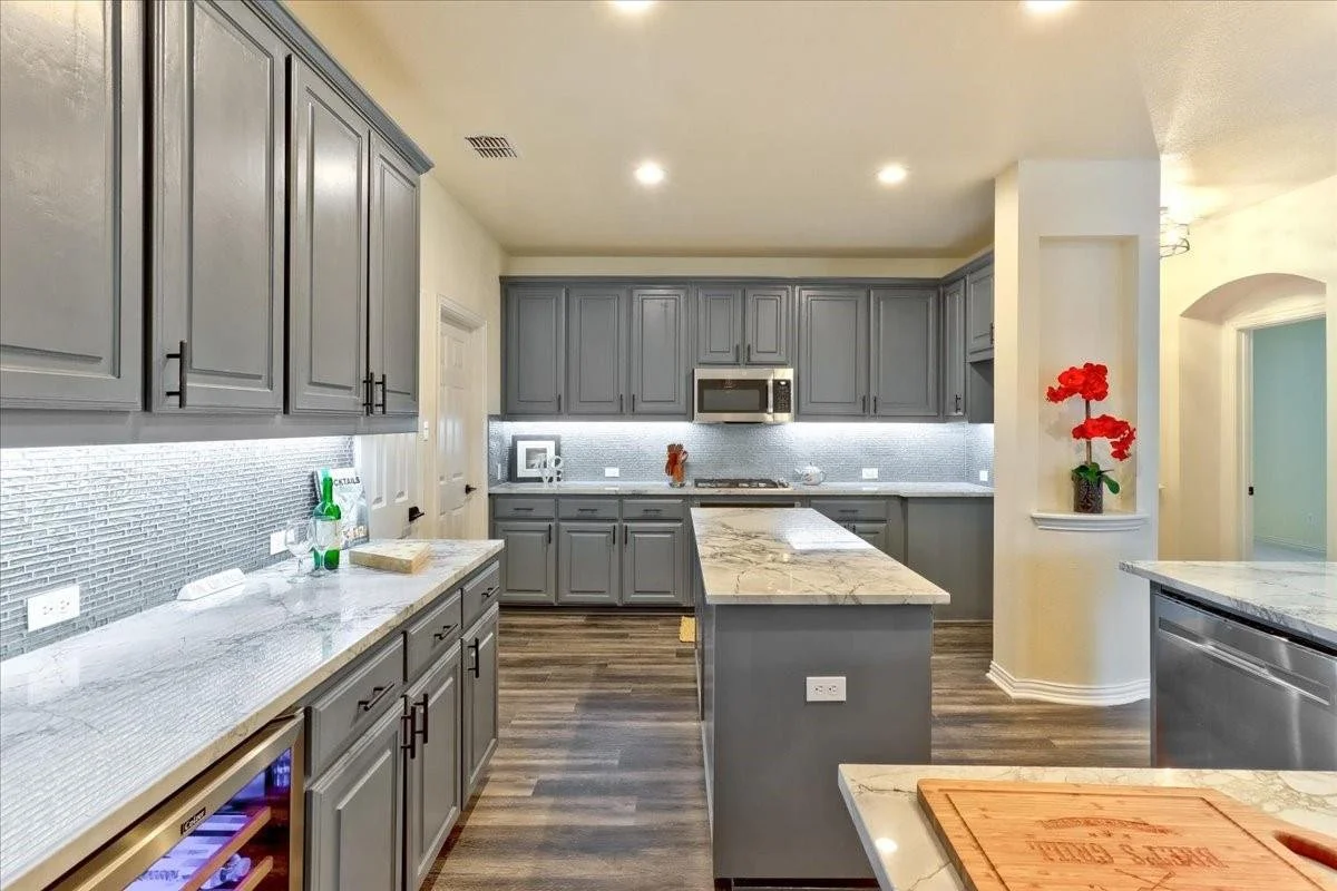 Kitchen: New countertops, backsplash, flooring, integrated lighting, high-end appliances, an under-counter wine cellar, custom cabinetry, and a modern color palette create an inviting atmosphere