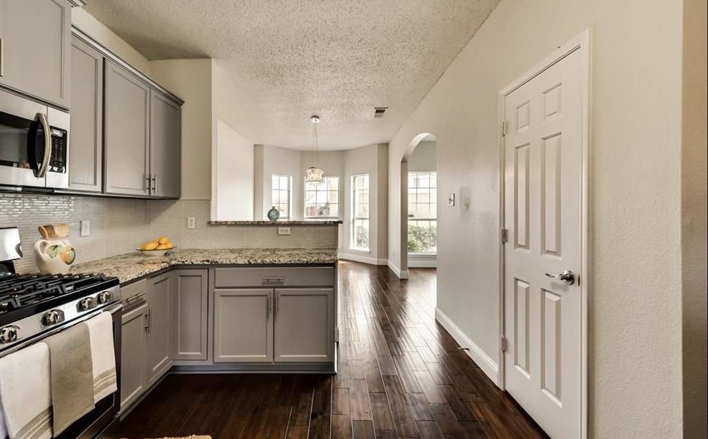 Kitchen: Updated finishes and light reflective surfaces now harmonize with the adjacent dining room, creating a seamless flow of natural light and a cohesive, open-concept feel