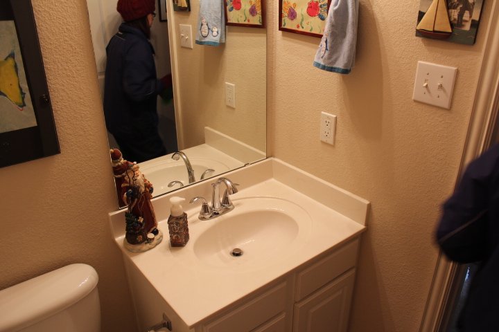 Half Bathroom: Inefficient lighting and dated fixtures obscured the potential of this small footprint (Before)