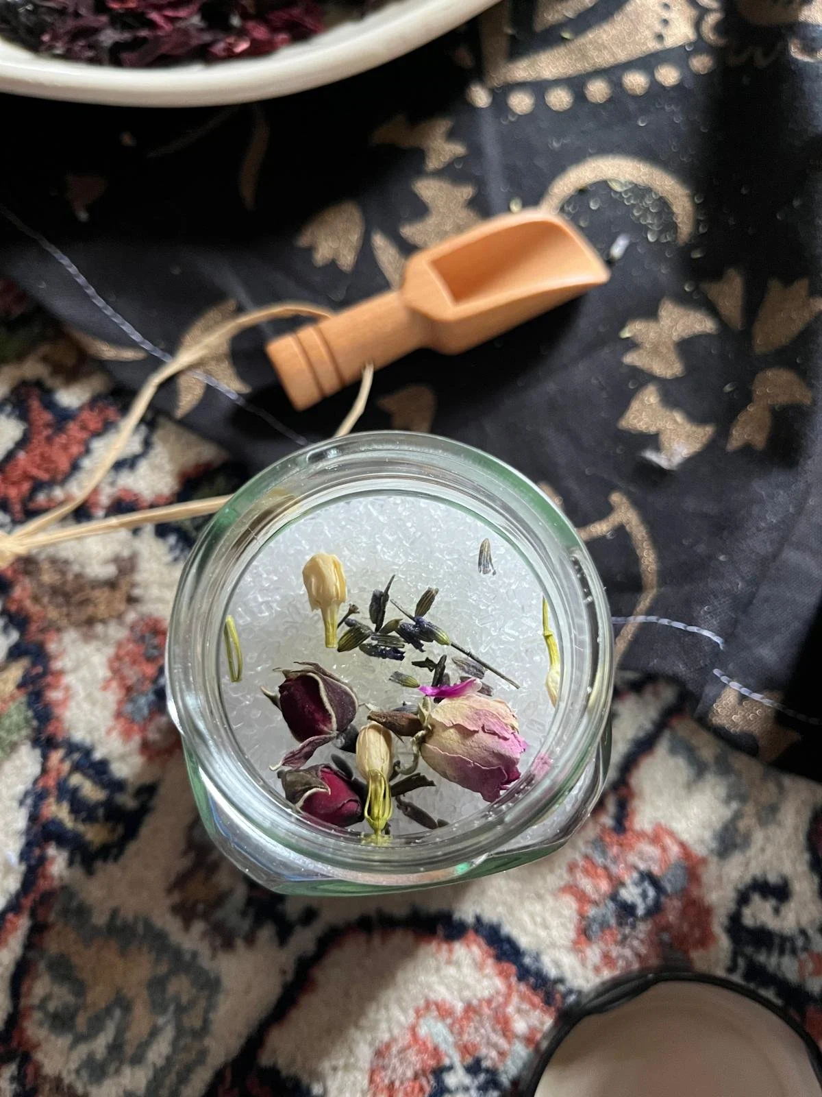 Mother blessing ceremony or blessingway hosted by Your Doula Aurelia. Image shows jar with salts, dried flowers and herbs made for the mother