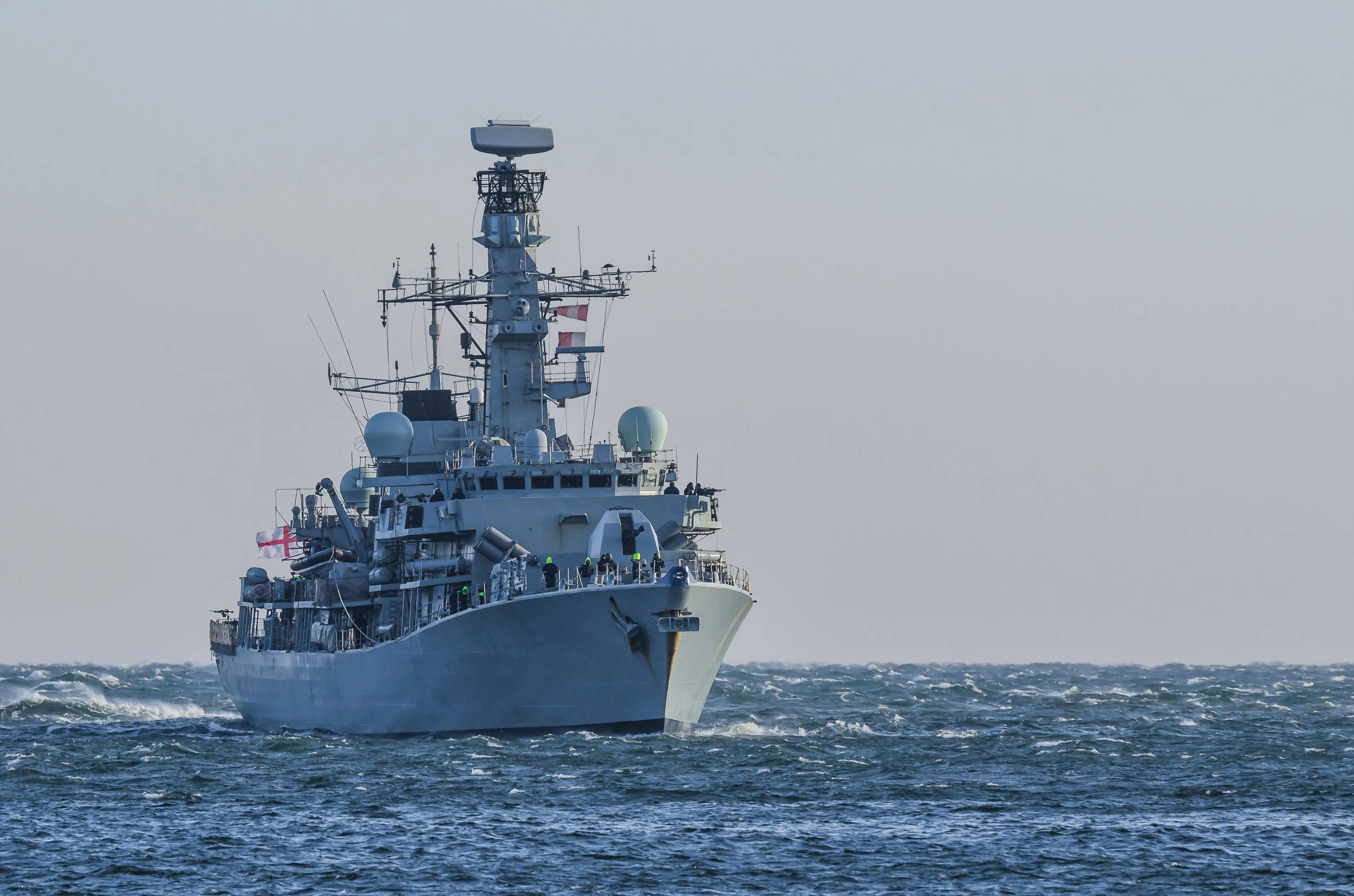 Naval vessel housing combat control systems, helicopters, and drone warefare