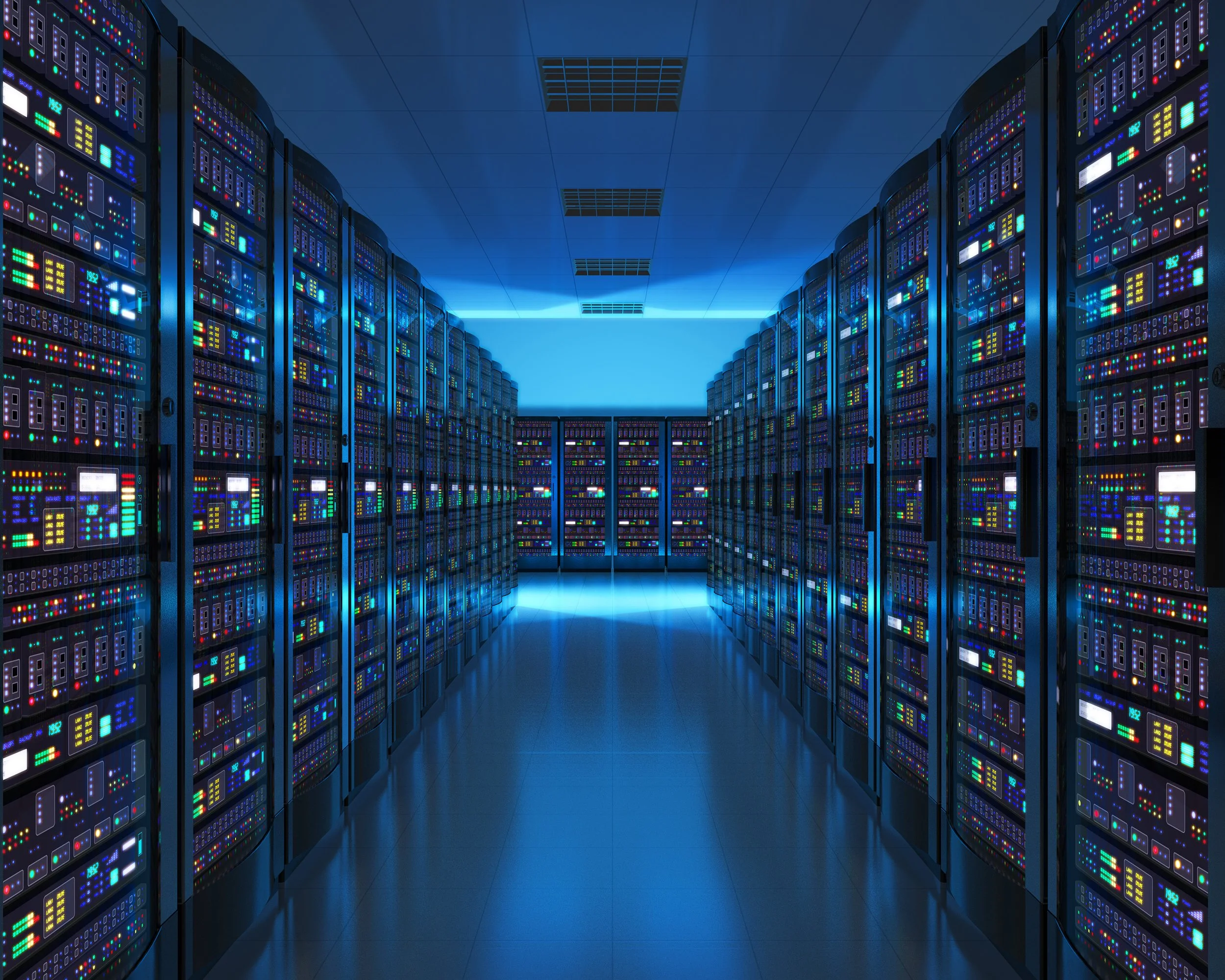 Interior of a data center with rows of server racks filled with colorful LED lights, illuminated in cool blue lighting and reflecting on the floor.