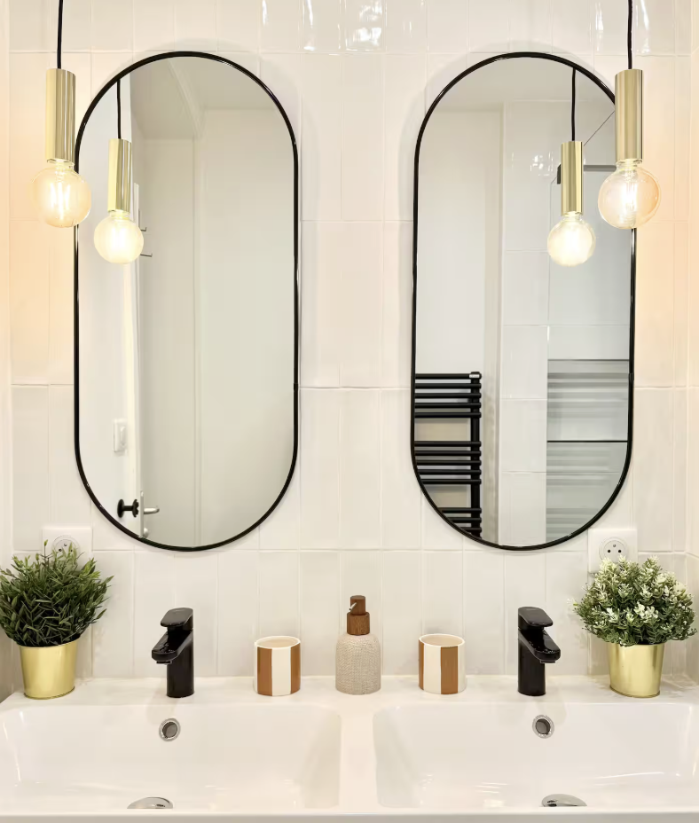 Salle de bain rénovée à Lyon avec double vasque, robinetterie noire et miroirs – projet d’architecture d’intérieur élégant et fonctionnel