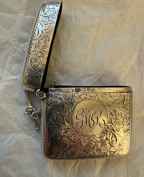 Silver decorative Vesta case with engraved floral pattern and a monogram 'GR' in the center.
