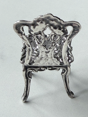 Delicate sterling silver miniature dolls’ house chair.