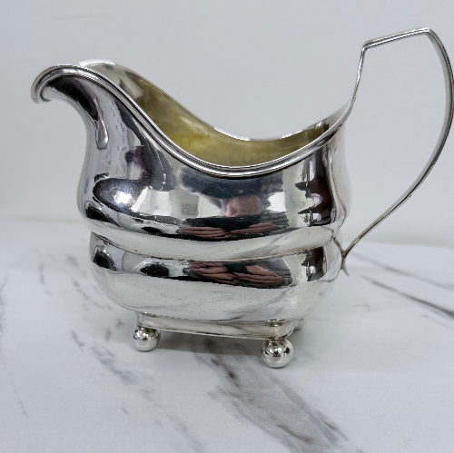 Elegant George III Irish sterling silver sauce boat of rectangular form on ball feet, by William Doyle, Dublin 1808.