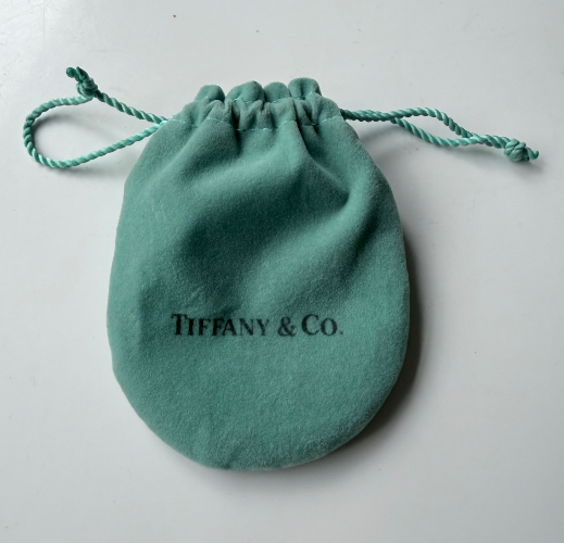 Genuine Tiffany & Co. sterling silver bangle bracelet with classic “1837” and Tiffany marks.
Comes with original pouch/box elements.