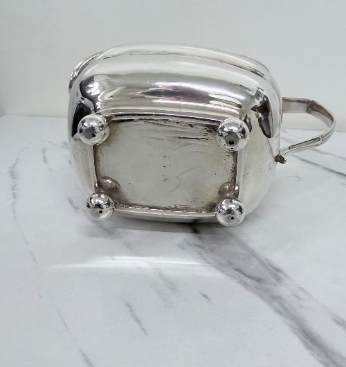 Elegant George III Irish sterling silver sauce boat of rectangular form on ball feet, by William Doyle, Dublin 1808.