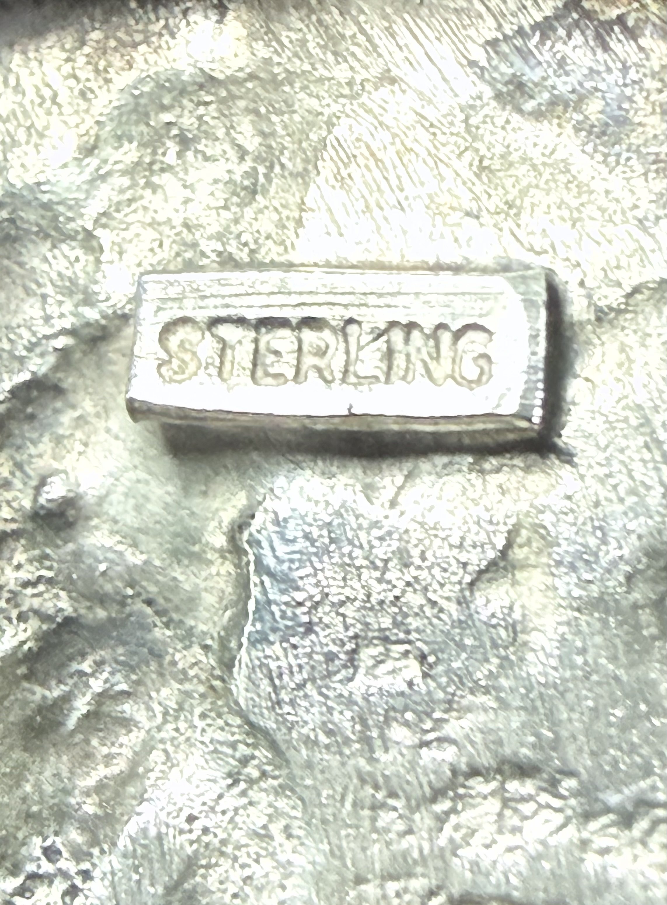 Close-up of  the word 'STERLING' engraved on it.