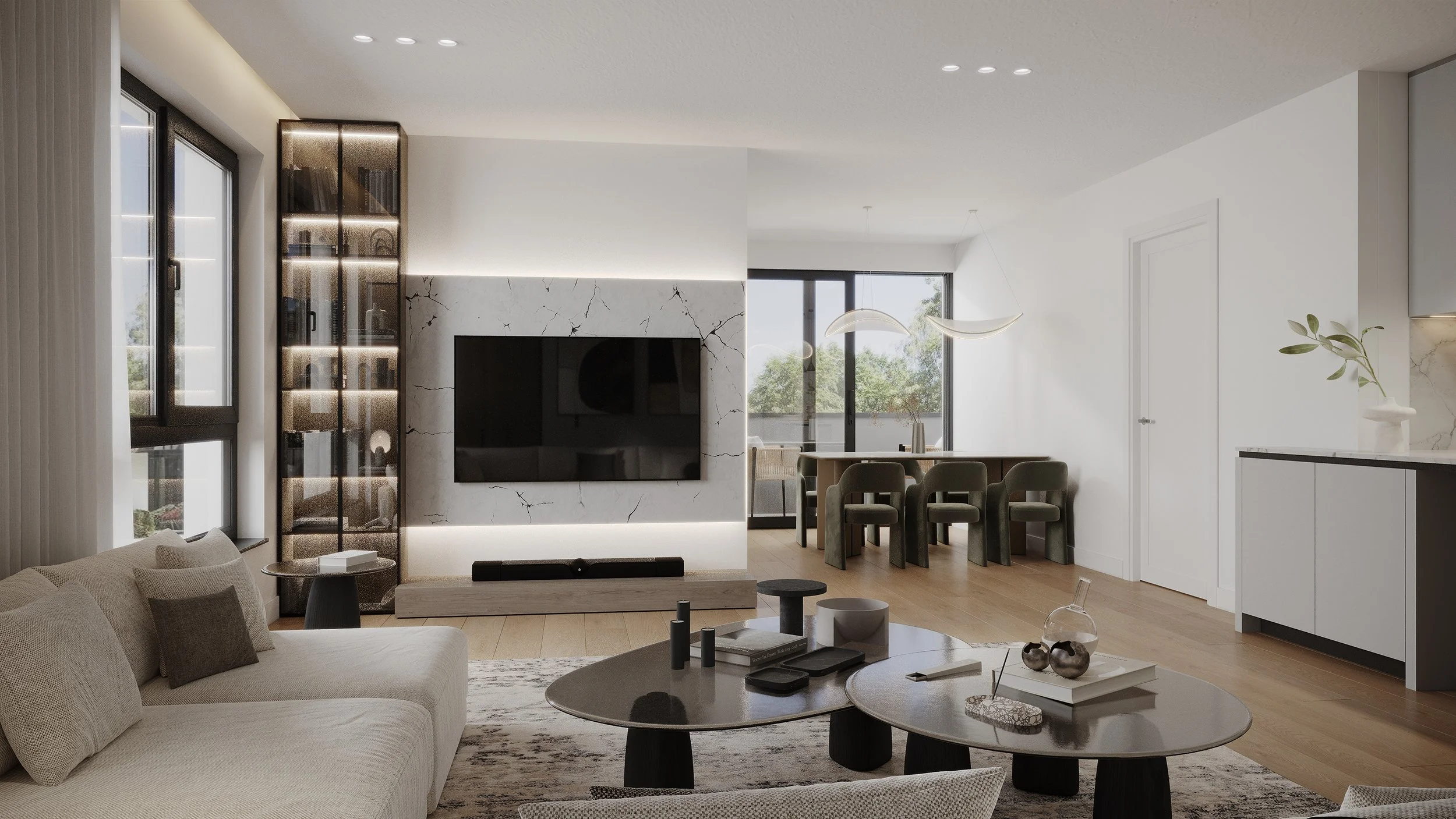 Modern living room with beige sofa, round coffee tables, and a TV mounted on a white marble wall, next to a glass door and window. Dining area with green chairs and pendant lights in background.