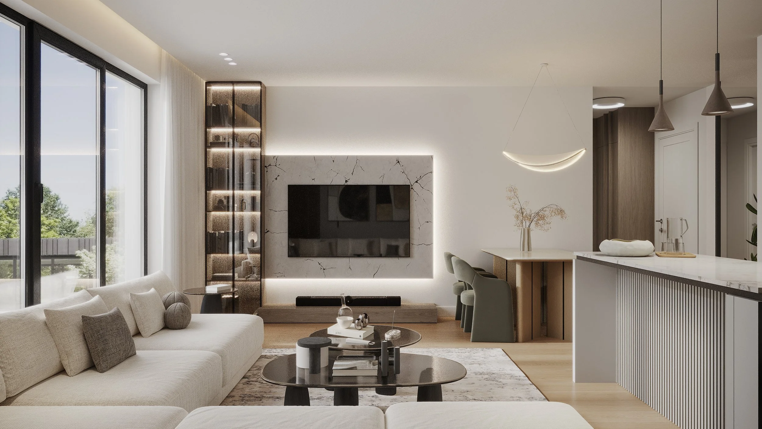 Modern living room with large windows, white sofa, round coffee table, wall-mounted TV on a marble accent wall, built-in bookshelf, dining area with a vase of dried flowers, and kitchen with a white marble countertop and pendant lighting.