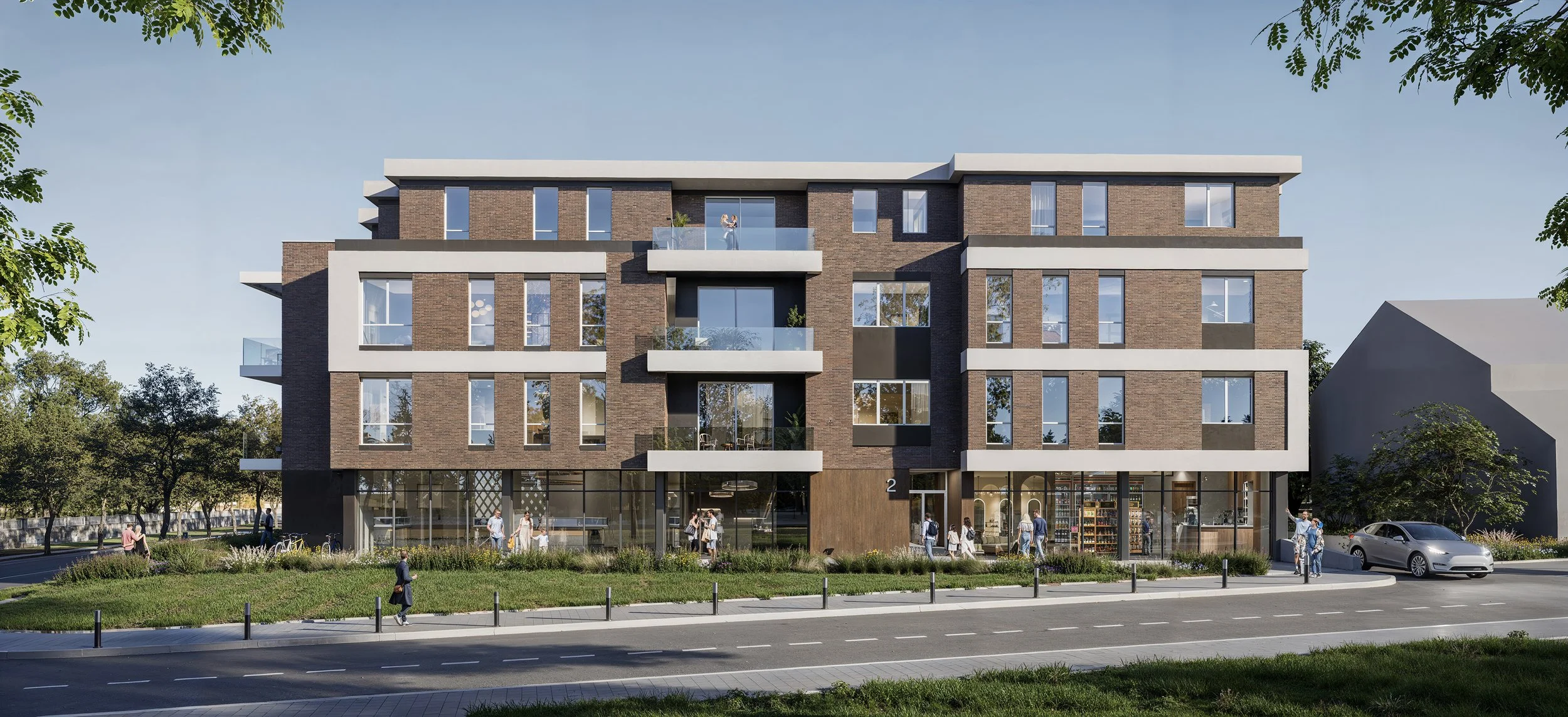 Modern multi-story residential building with commercial spaces on the ground floor, balconies, and large windows. People are walking and biking outside, and a silver car is parked on the street. Trees and greenery line the sidewalk.