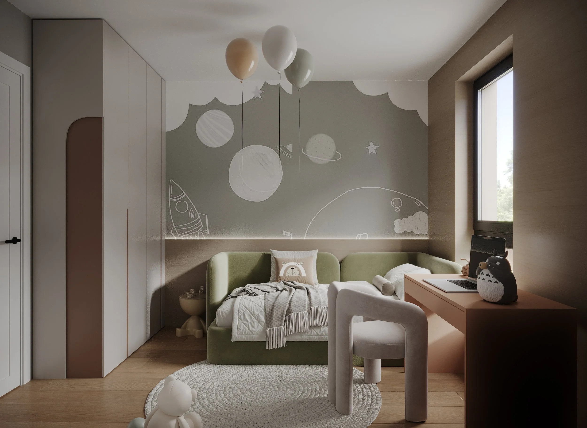 A cozy children's bedroom with a space-themed wall mural, green bed, white and beige bedding, a small beige side table, a peach-colored desk with a laptop and a penguin-shaped plush toy, a light-colored chair, a white circular rug, and a window with 