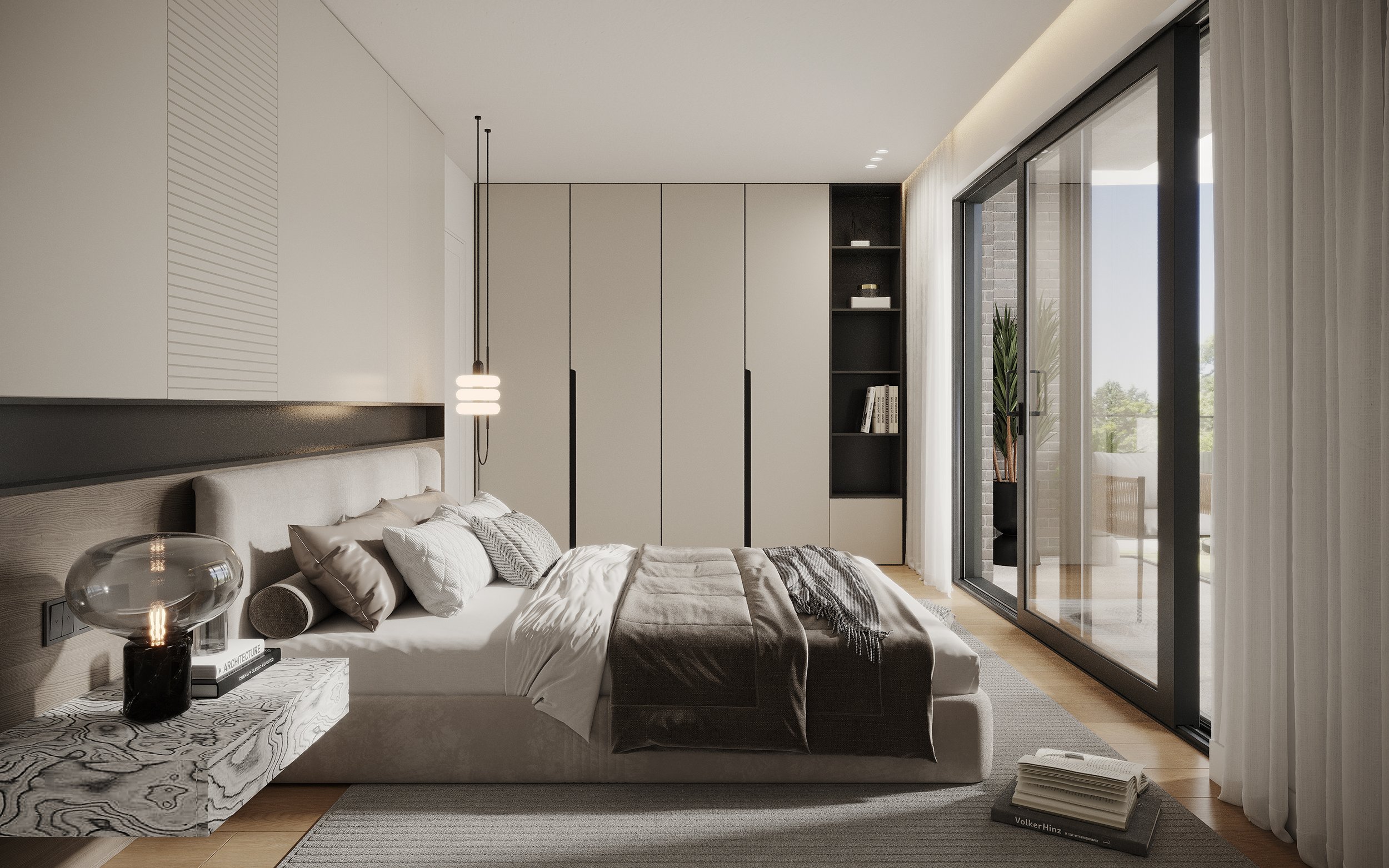 Modern bedroom with a large bed, nightstand with decorative lamp, built-in wardrobe, and sliding glass door leading to a balcony with outdoor seating.