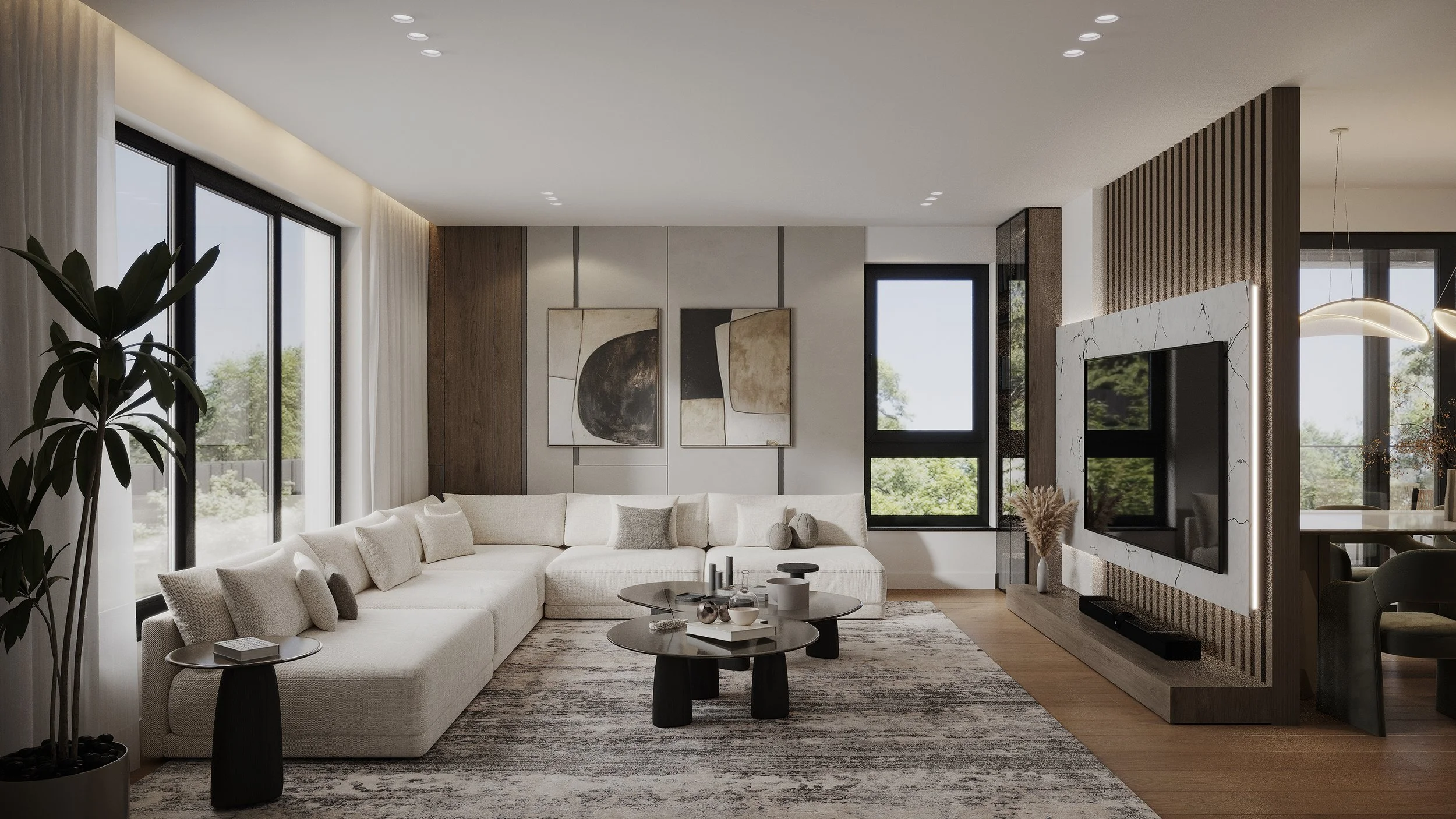 Modern living room with large white sectional sofa, abstract art on the wall, black and wooden coffee tables, a flat-screen TV on a decorative marble and wood panel, and large windows with outdoor views.