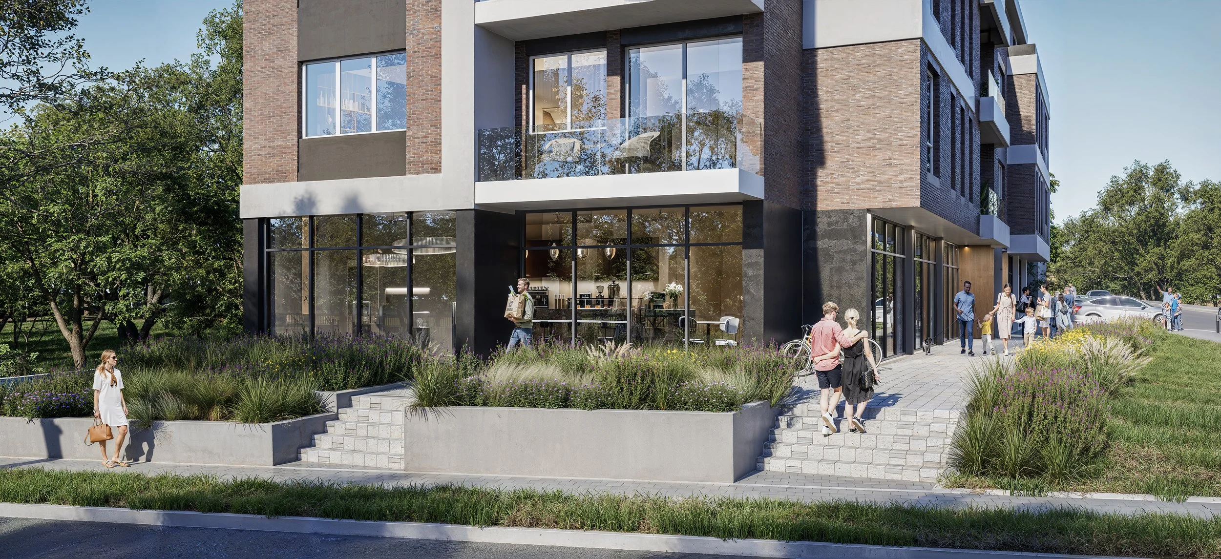 A modern building with large glass windows and brick facade, surrounded by greenery and people walking on a paved sidewalk outside a coffee shop or café.