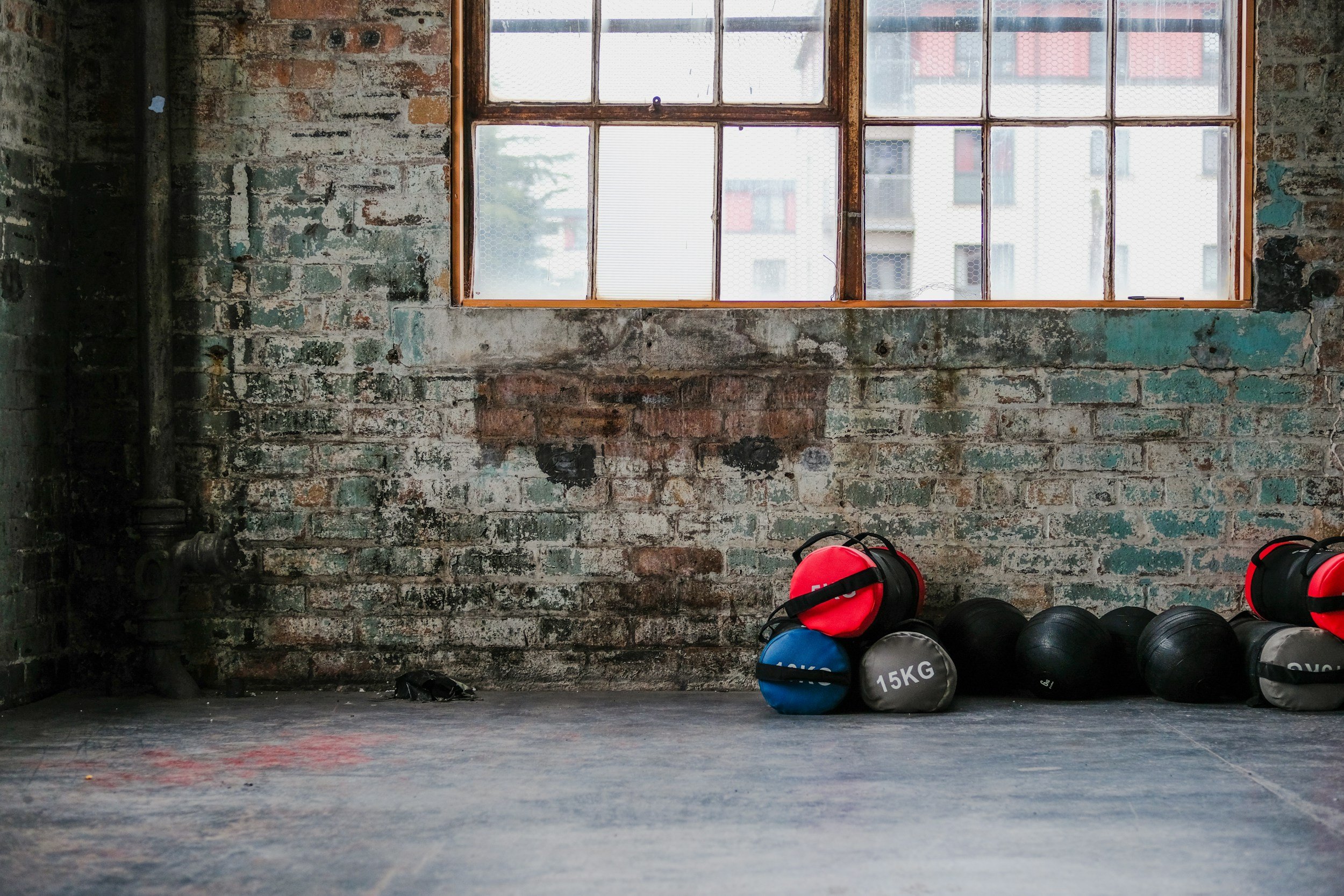 LifeFit functional resistance tools, including kettlebells and medicine balls, arranged for a high-efficiency clinical-adjacent strength protocol