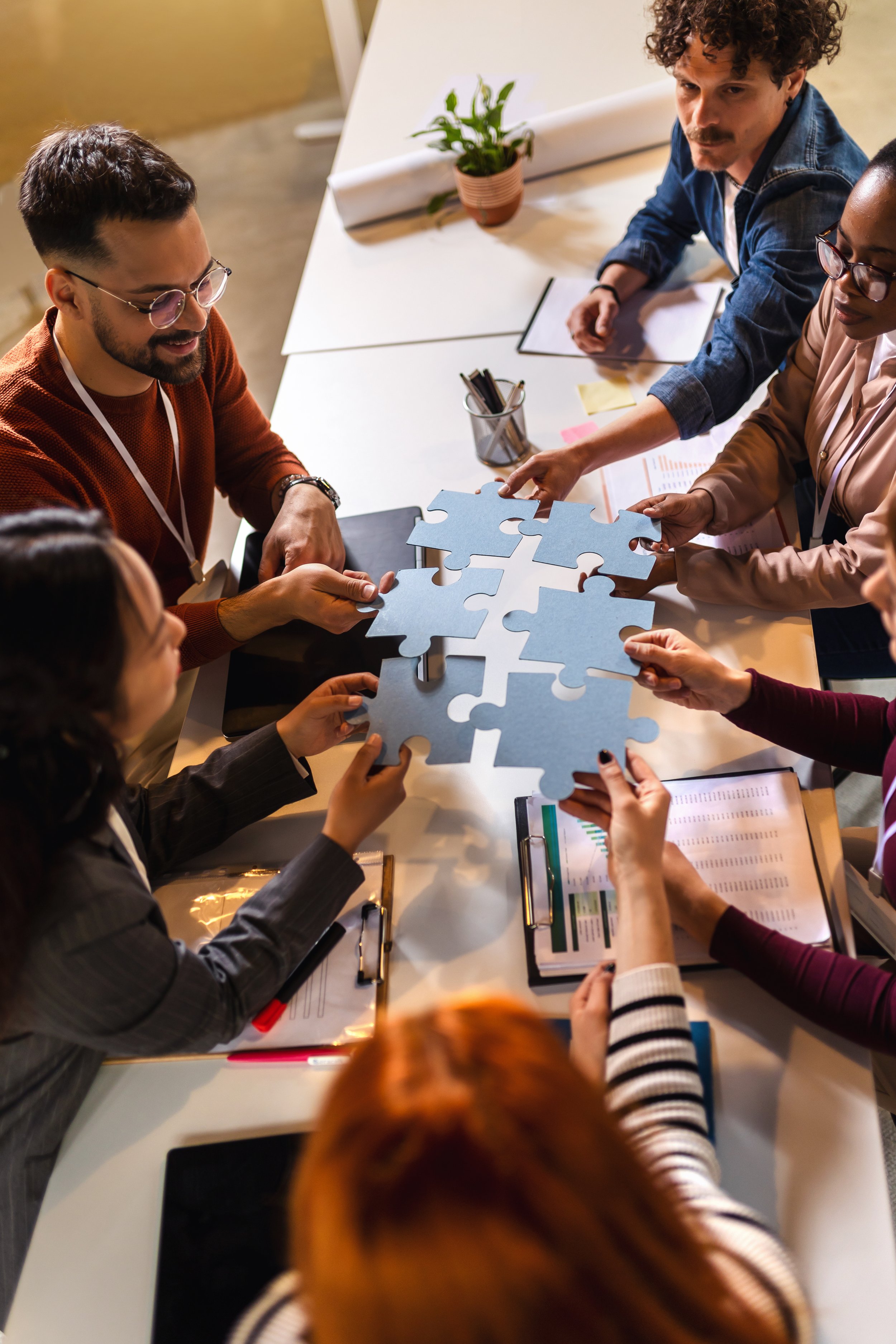 Corporate Team gathered around a table problem solving