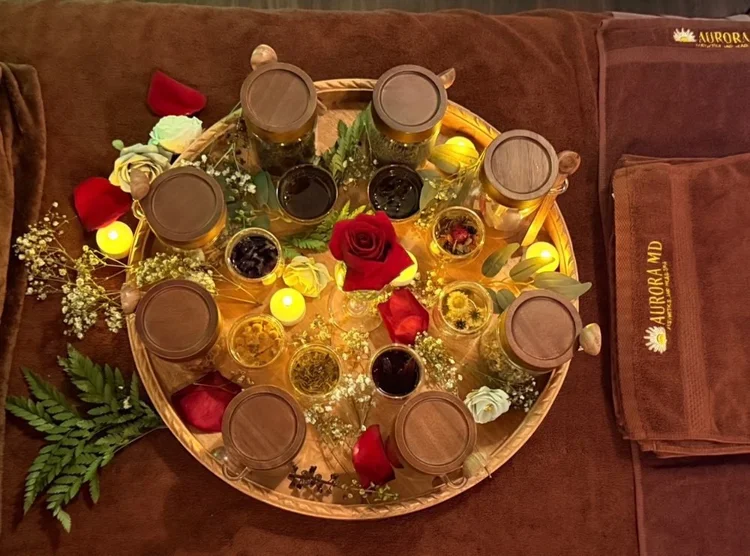 Candlelit tray of herbal teas and roses for the Royal Radiant Ritual