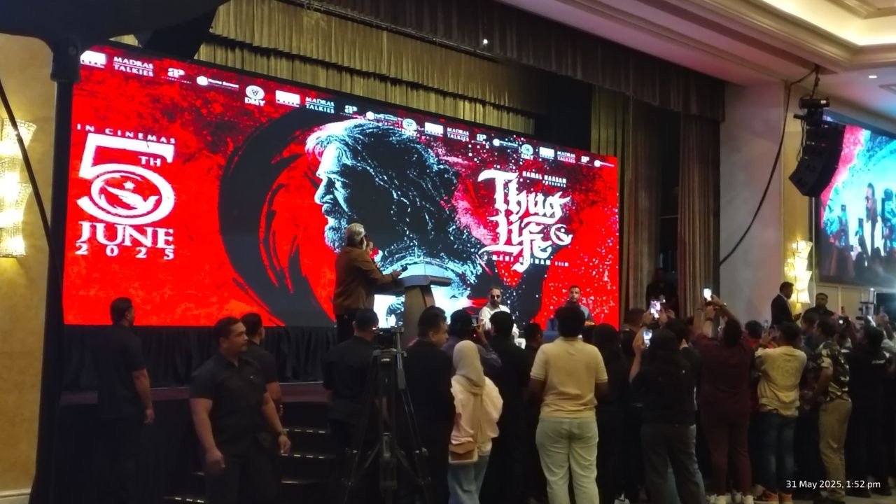 A large event with a presentation or announcement taking place on a stage with a big screen displaying a promotional poster for a movie titled 'Lamb of God,' releasing in theaters on June 2, 2025. The poster features a silhouette of a person with lon