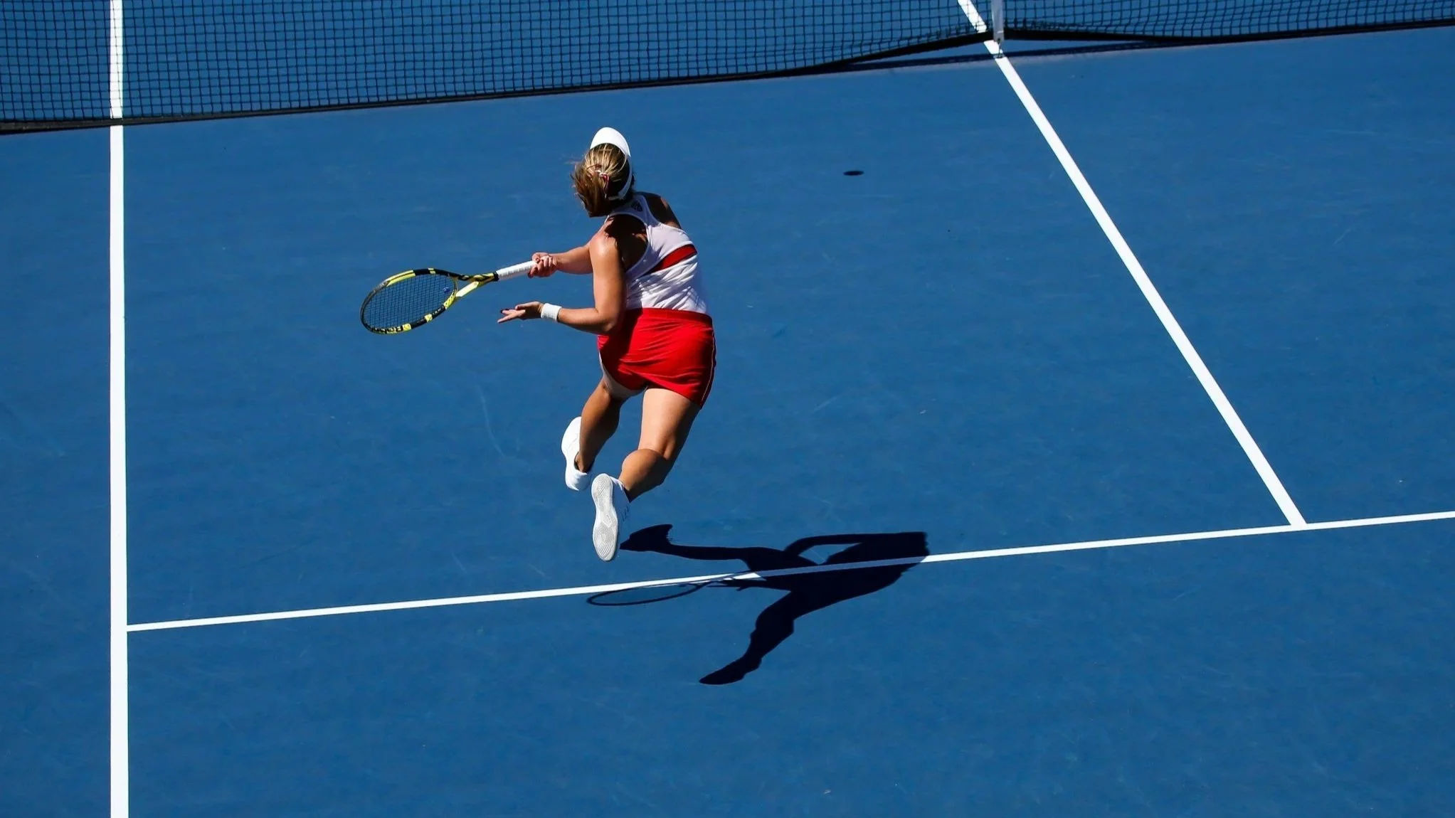 Female Tennis player hitting a forehand volley