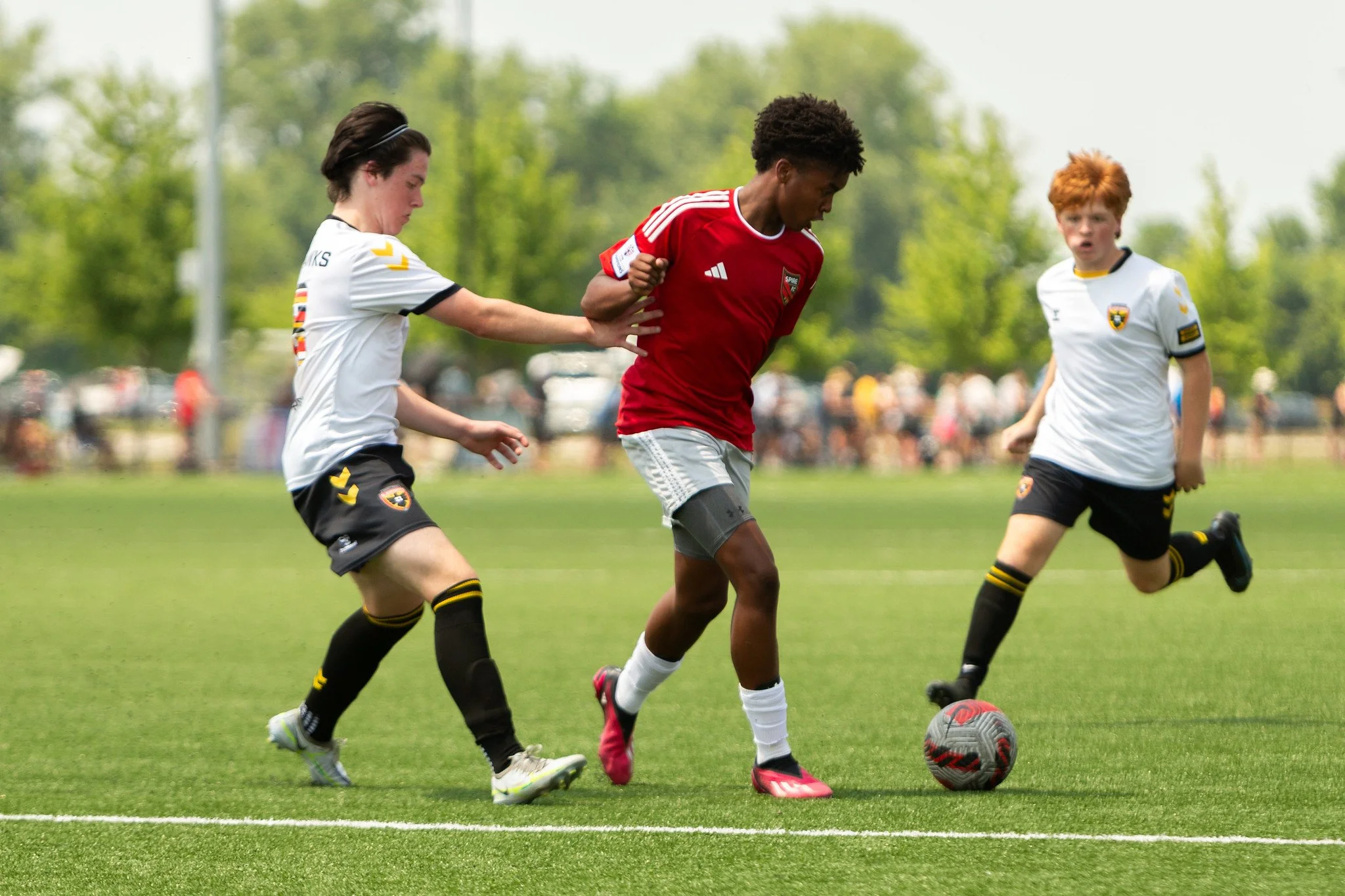 Youth playing soccer together
