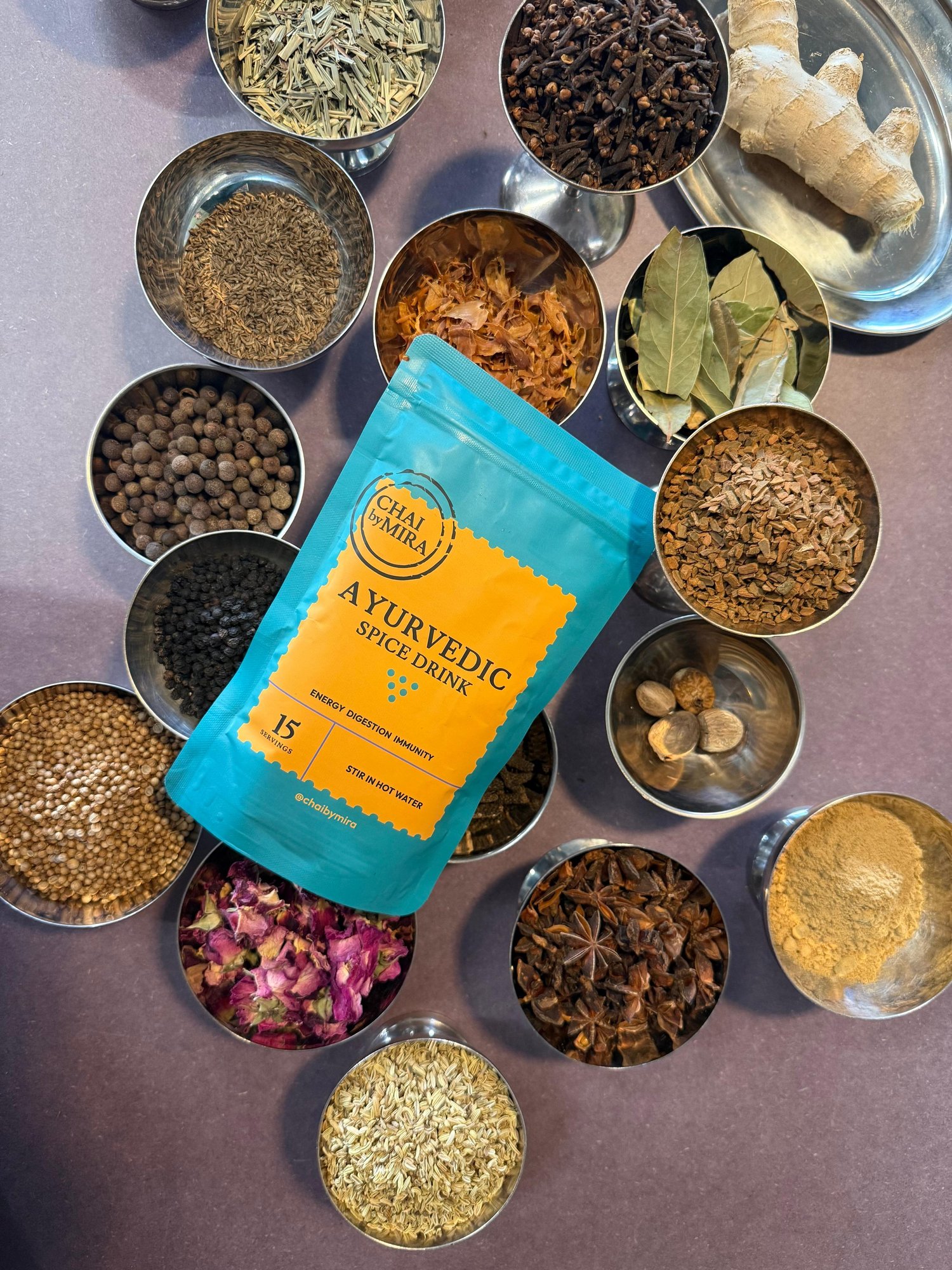 Ayurvedic Chai pouch surrounded by bowls of whole spices
