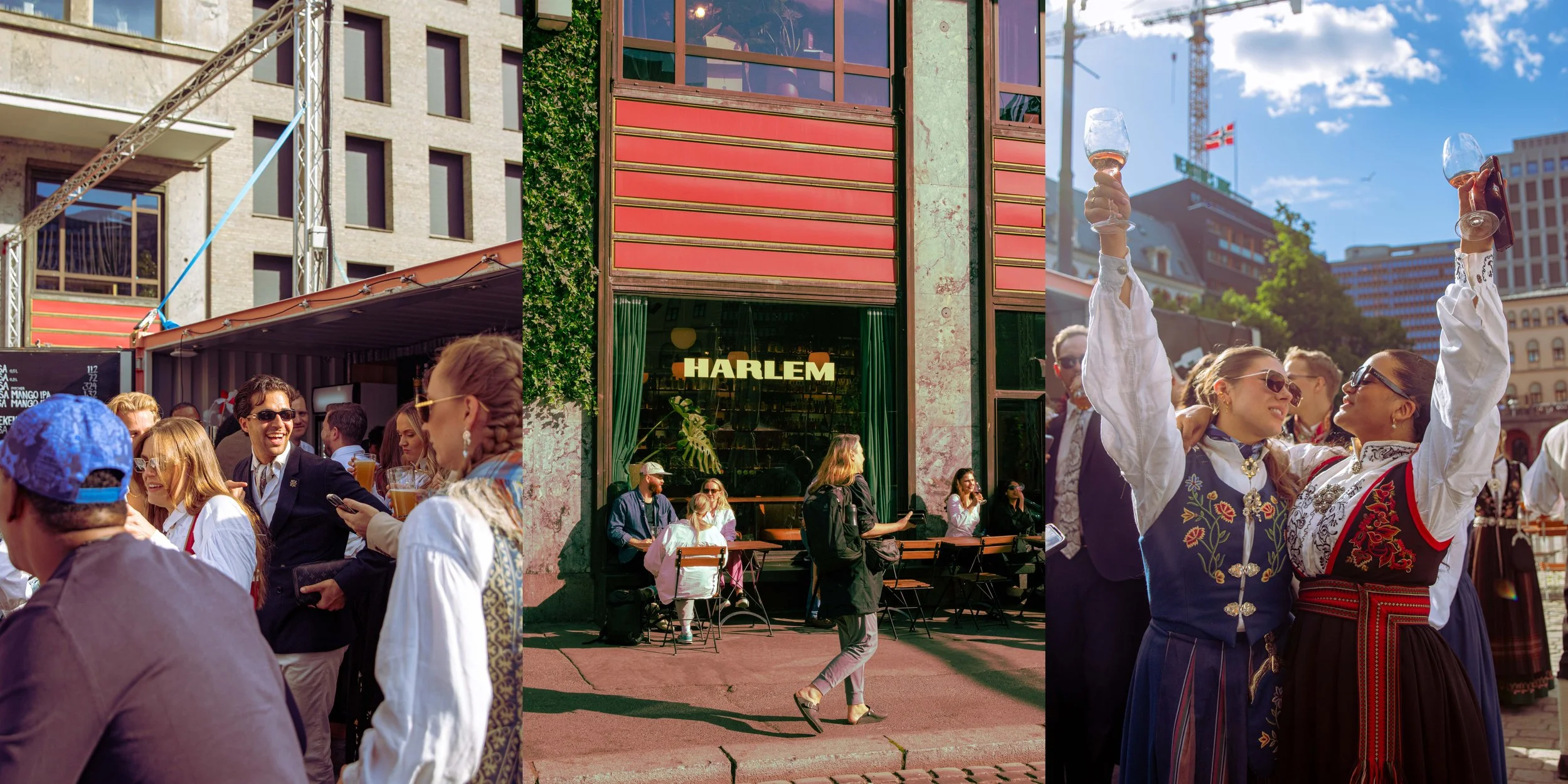 People gathered outdoors in a city square, enjoying drinks and socializing. Some are wearing traditional folk costumes, and the scene is lively with a mix of casual and festive attire. Buildings and a crane are visible in the background.