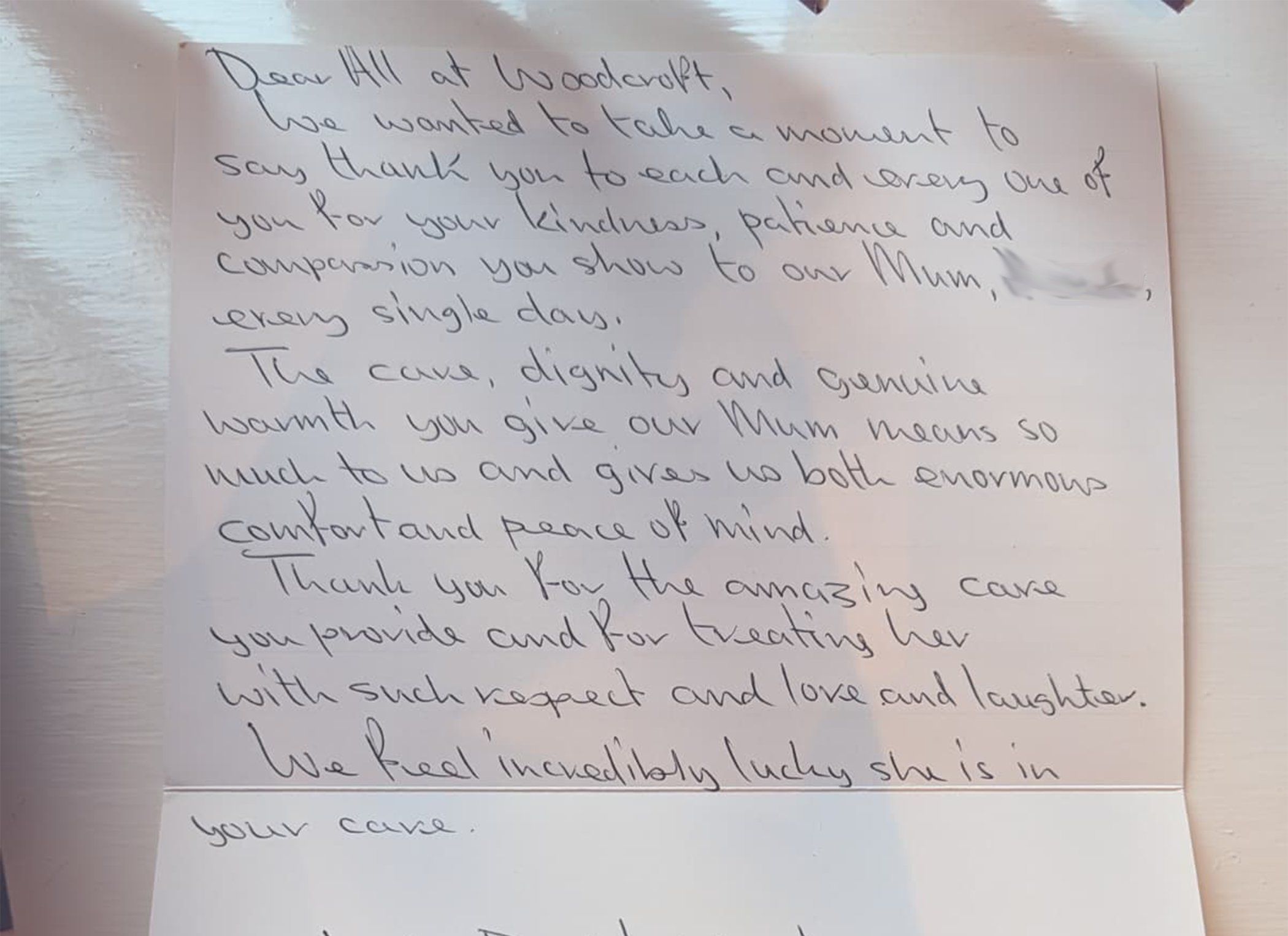 A handwritten note on a piece of paper, expressing gratitude to someone at Woodcraft for their kindness and support. The note is partially visible and slightly crumpled.