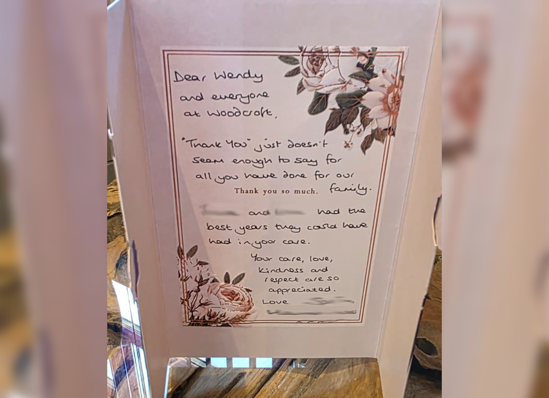 A handwritten thank you note addressed to Wendy and everyone at Woodcare, expressing appreciation for their help and care. The note features floral decorations with roses and leaves.
