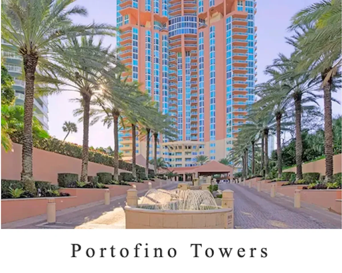 Tall pink and blue high-rise building called Portofino Towers with palm trees lining a driveway and a small fountain in the foreground.