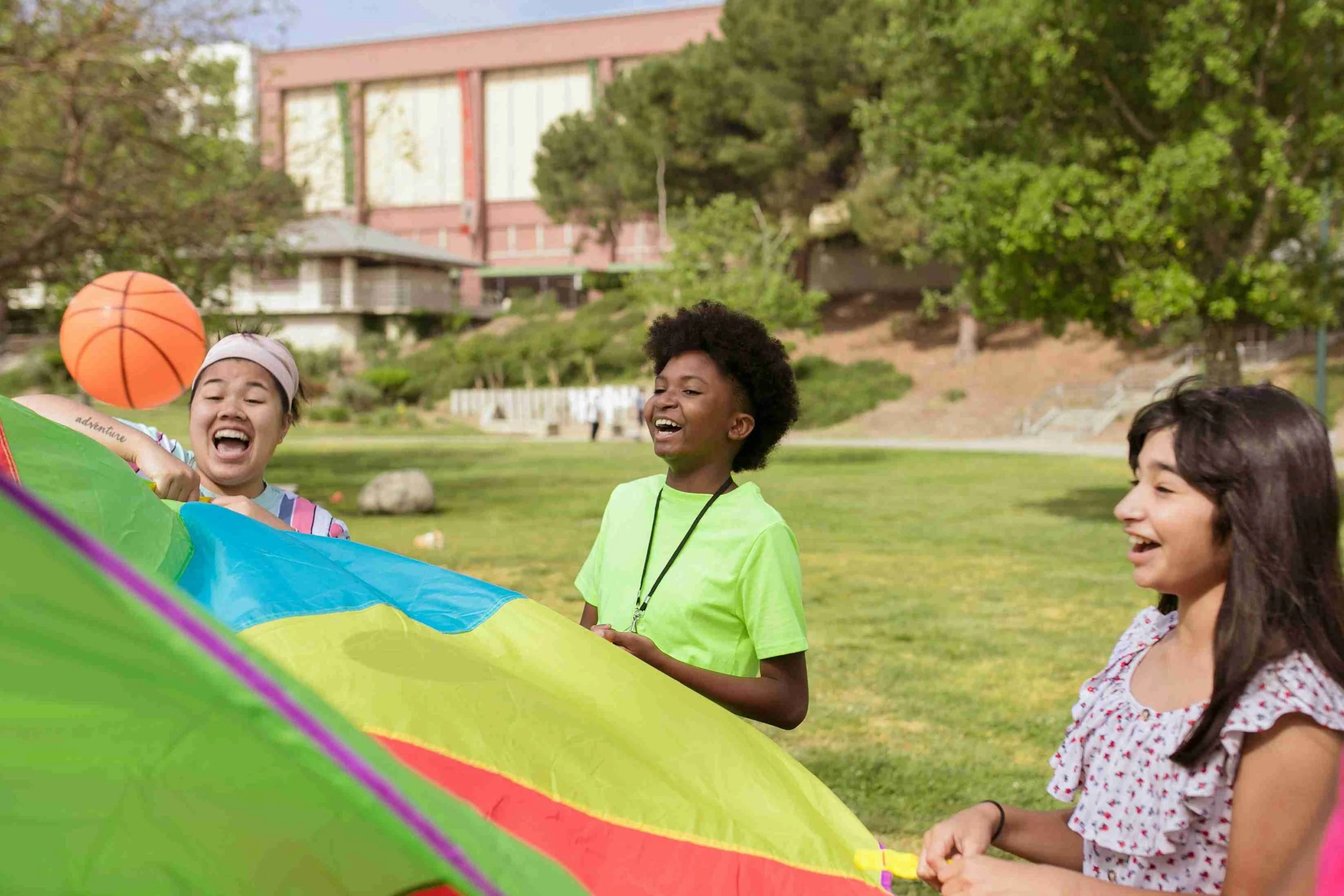 Yellow Wood Academy students enjoying outdoor physical education activity with a parachute game