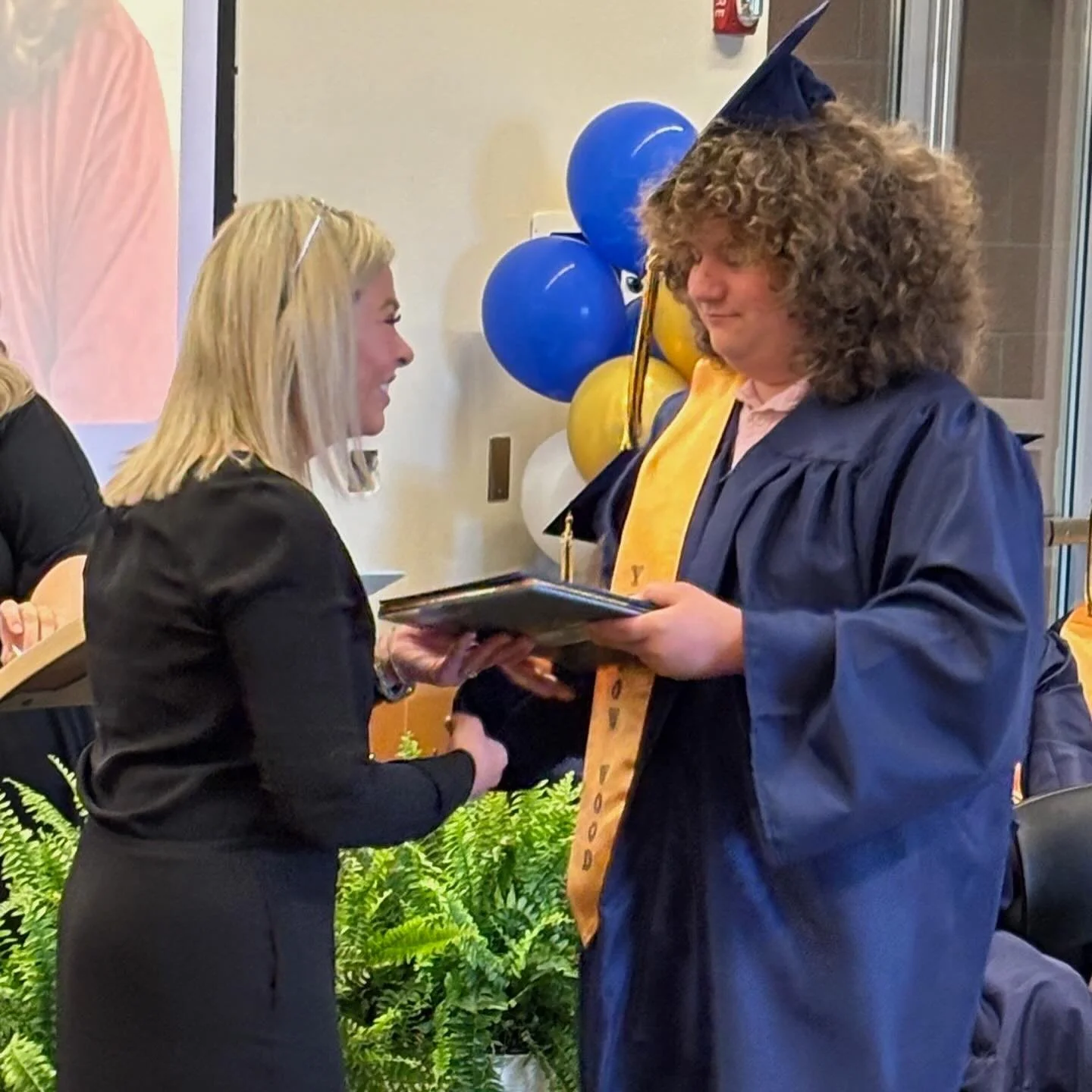 Yellow Wood Academy graduate receiving diploma during graduation ceremony