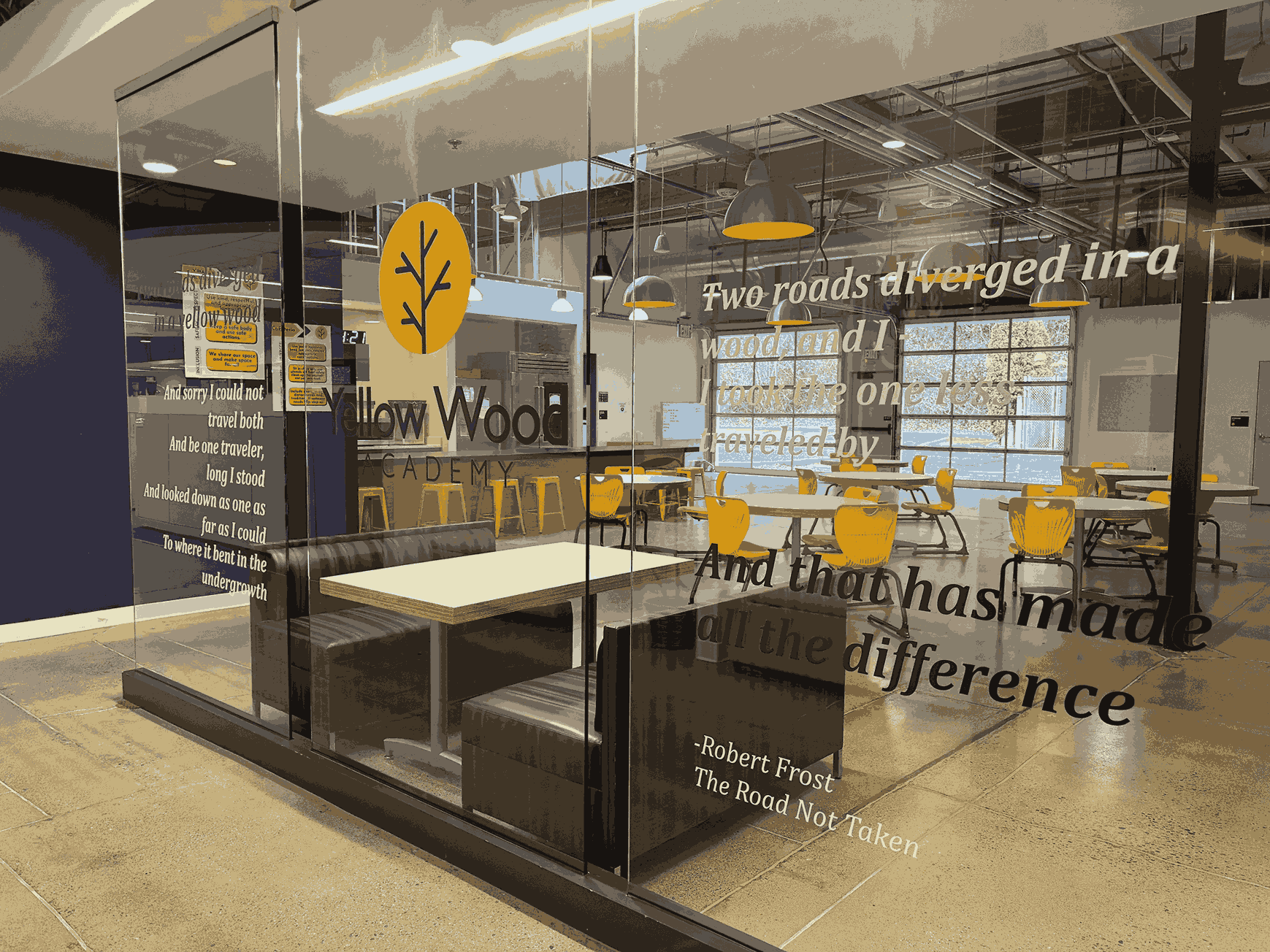 Yellow Wood Academy common area with glass walls, seating, and classroom space