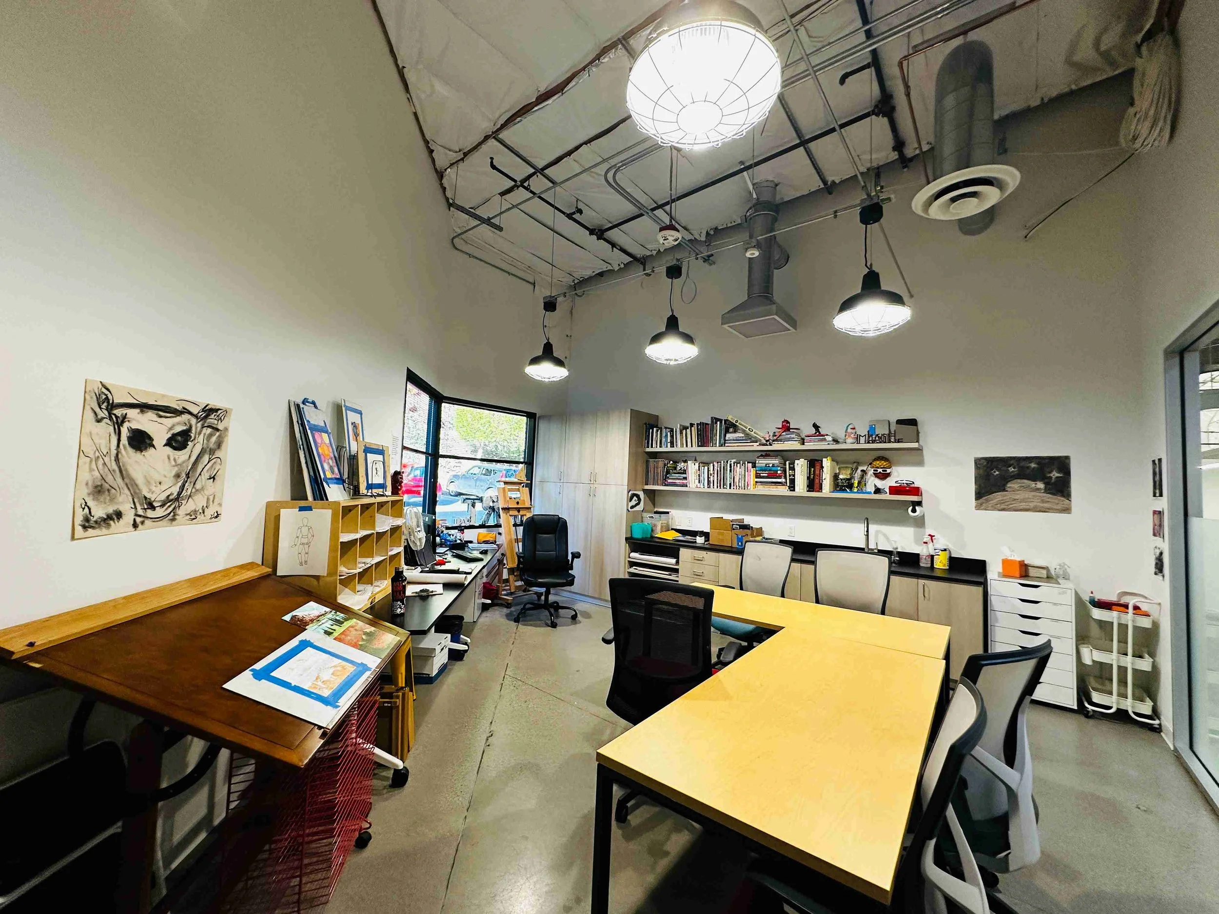 Yellow Wood Academy art room with drawing tables, supplies, and creative student workspace